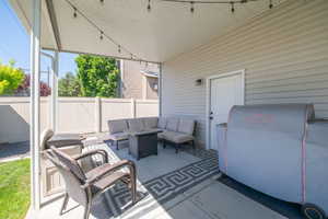Expansive covered patio featuring string lighting and direct exterior access
