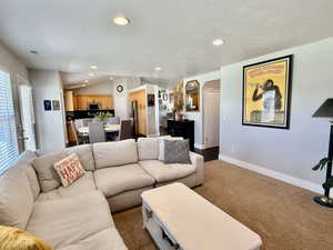 Living area featuring wall-to-wall carpeting and recessed lighting
