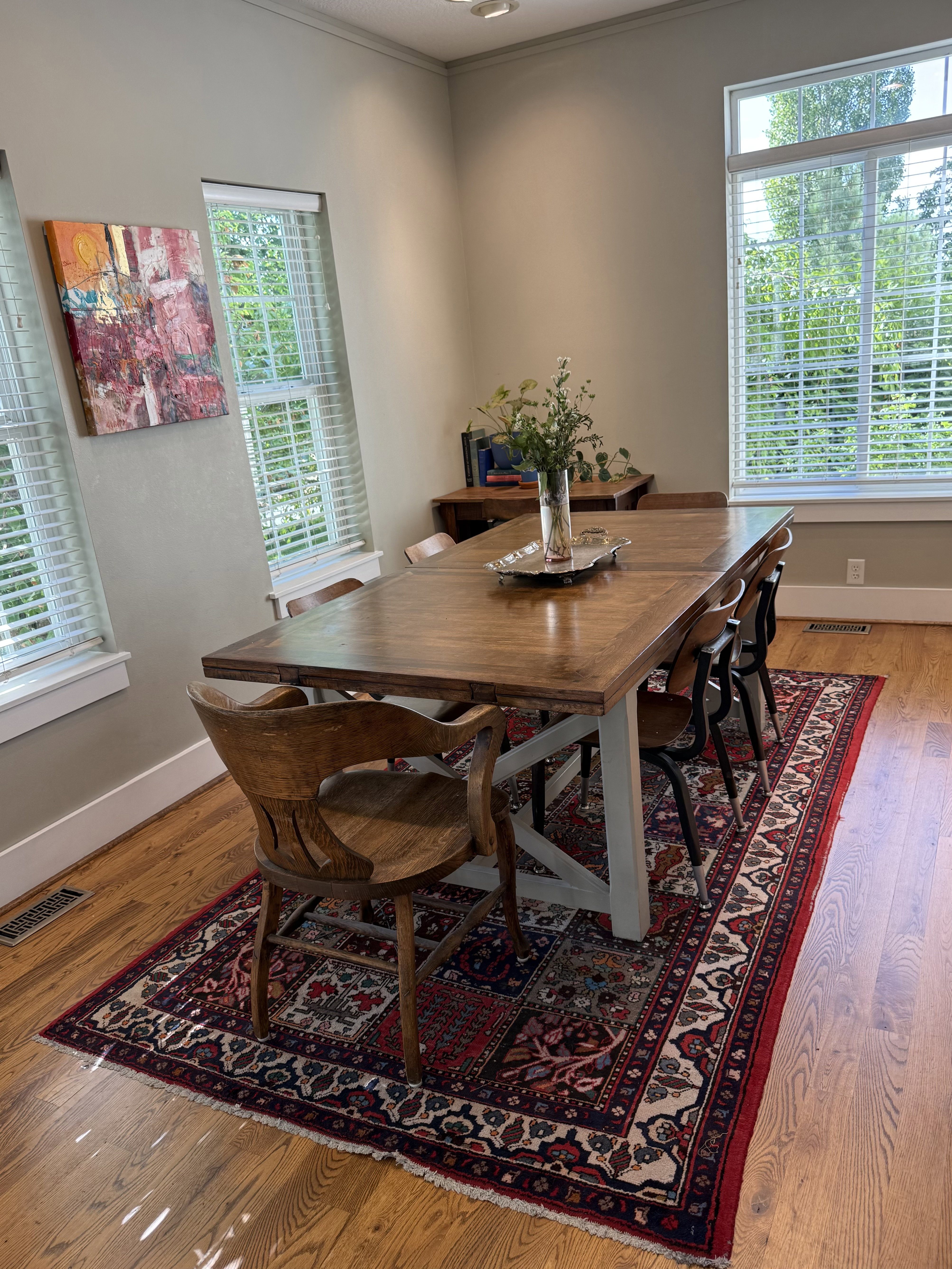 Dining area featuring wood-finish flooring, two large windows with blinds, crown molding, and recessed lighting