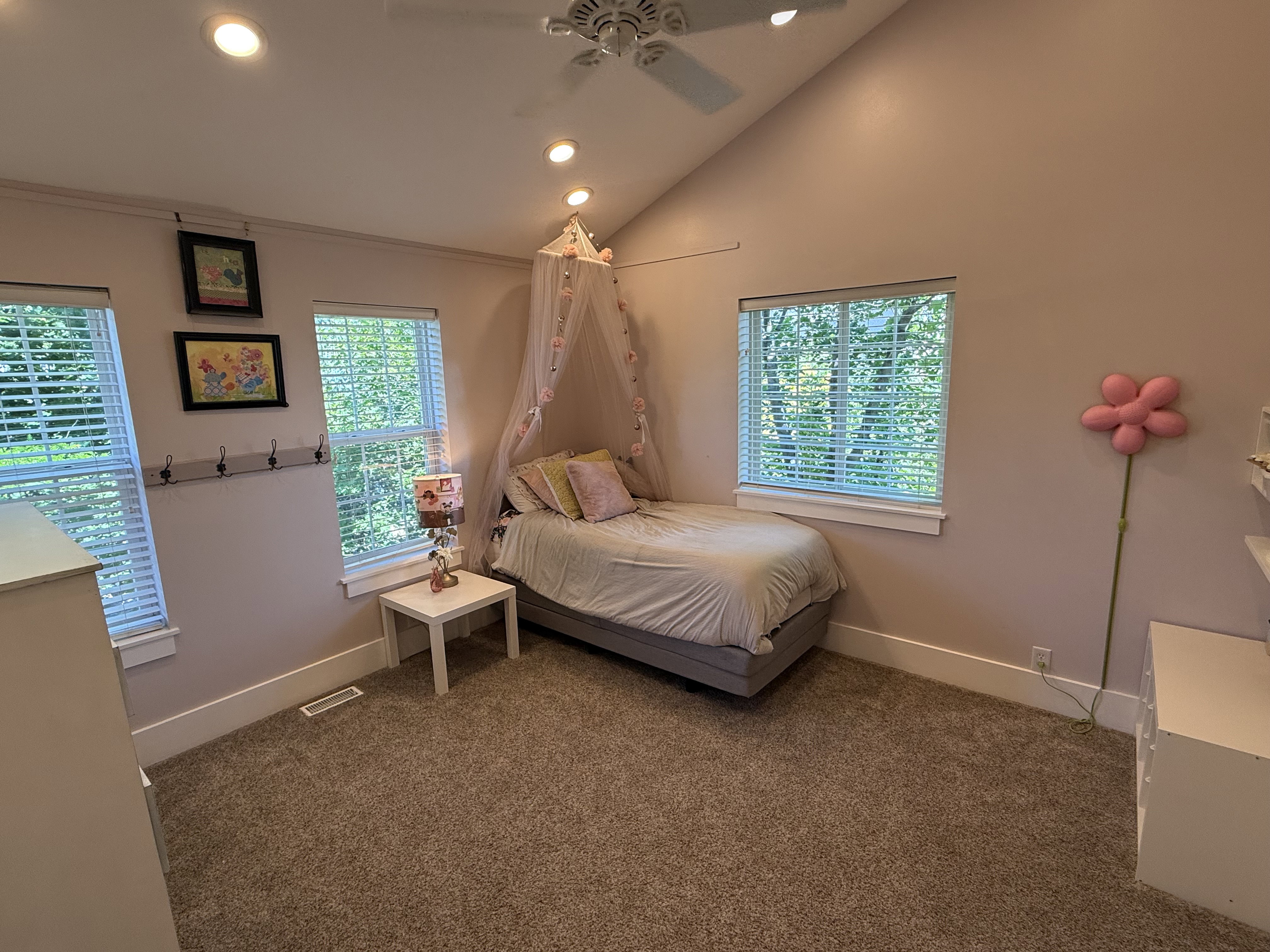 Carpeted room featuring a vaulted ceiling with recessed lighting and a ceiling fan