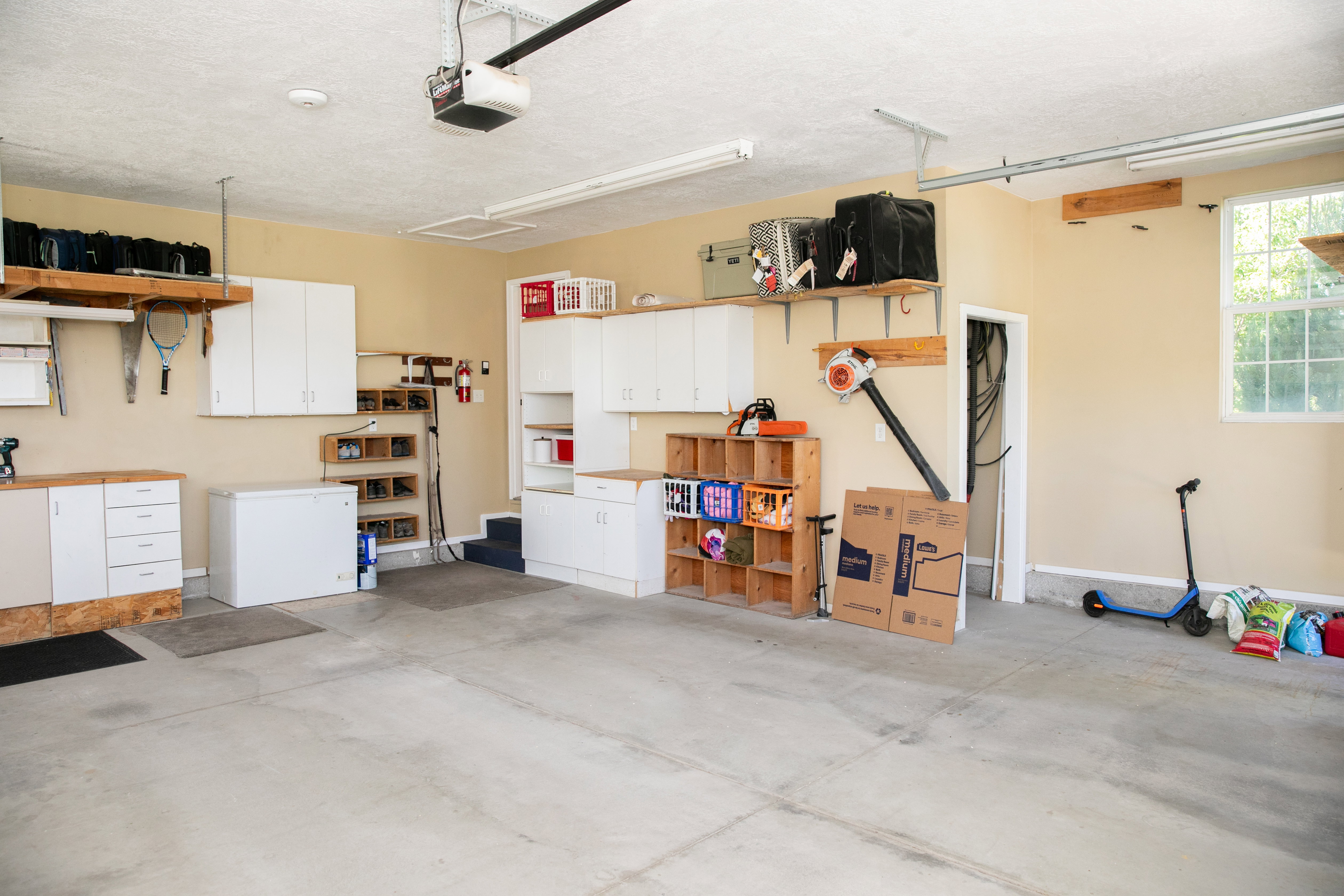 Spacious garage featuring concrete flooring and ample overhead lighting