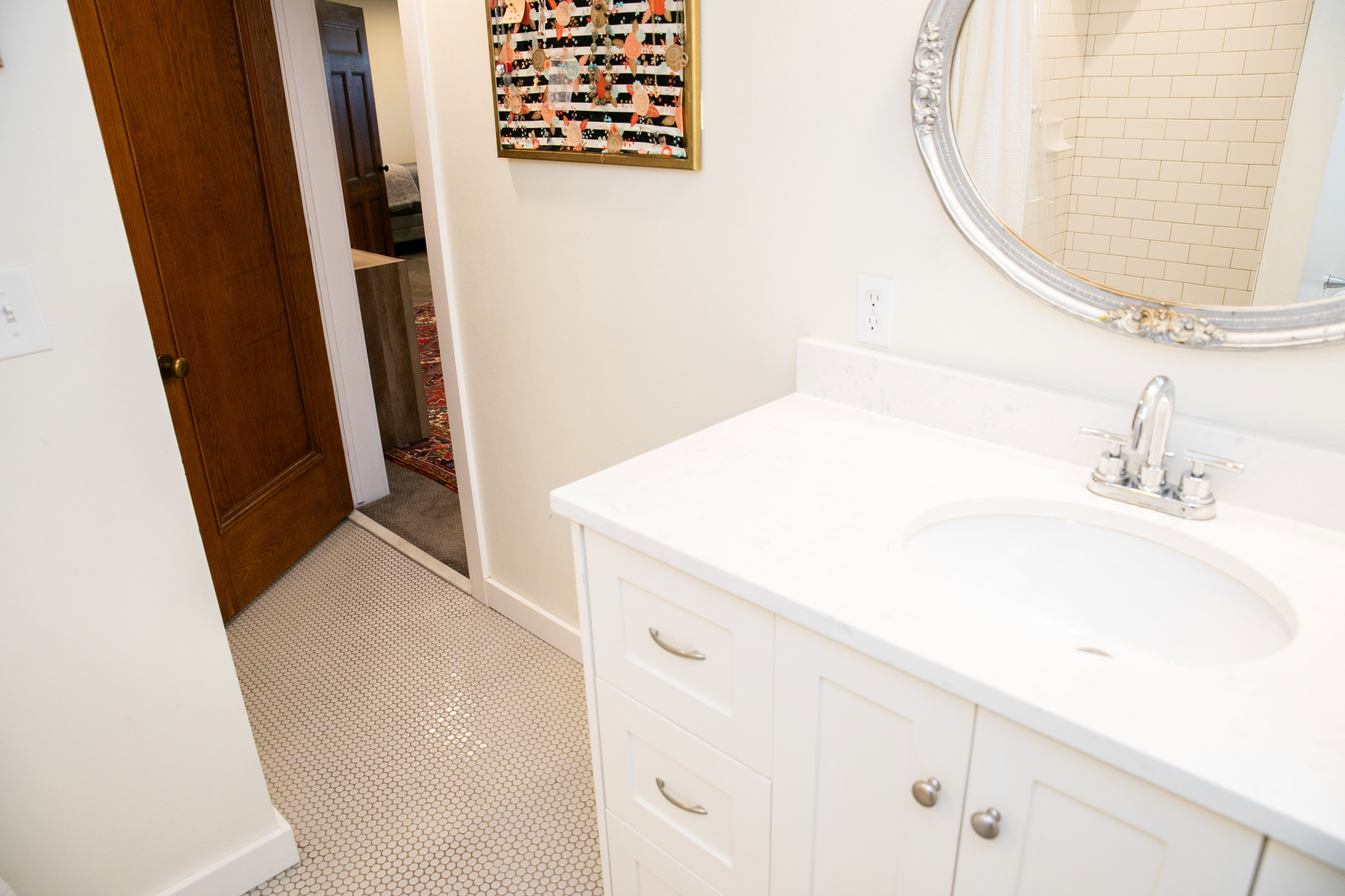 White vanity with an integrated sink, polished chrome faucet, and white countertop