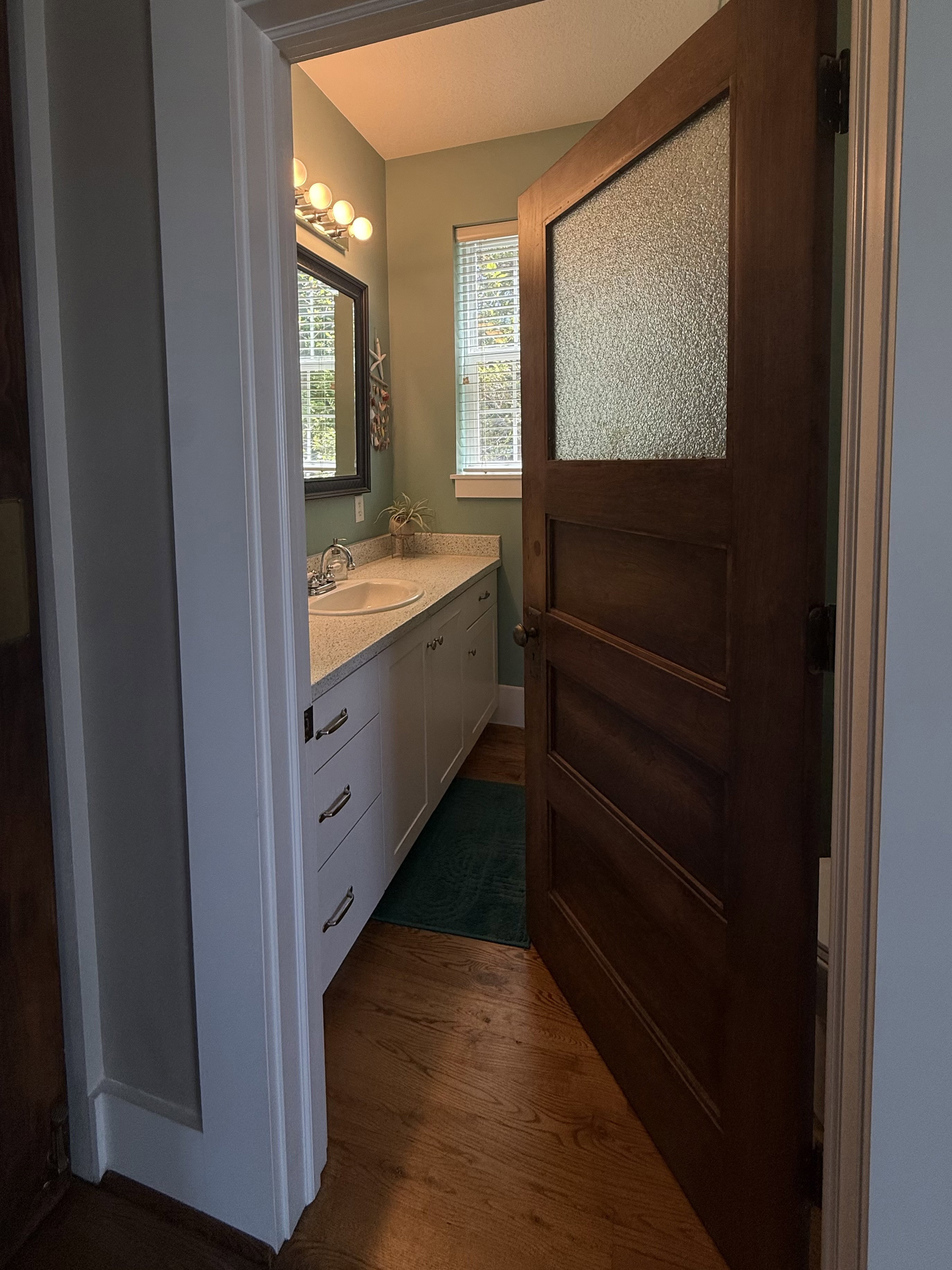Bathroom with a single vanity featuring an undermount sink and a light-toned countertop