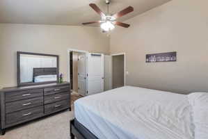 Vaulted ceiling with a ceiling fan and light fixture