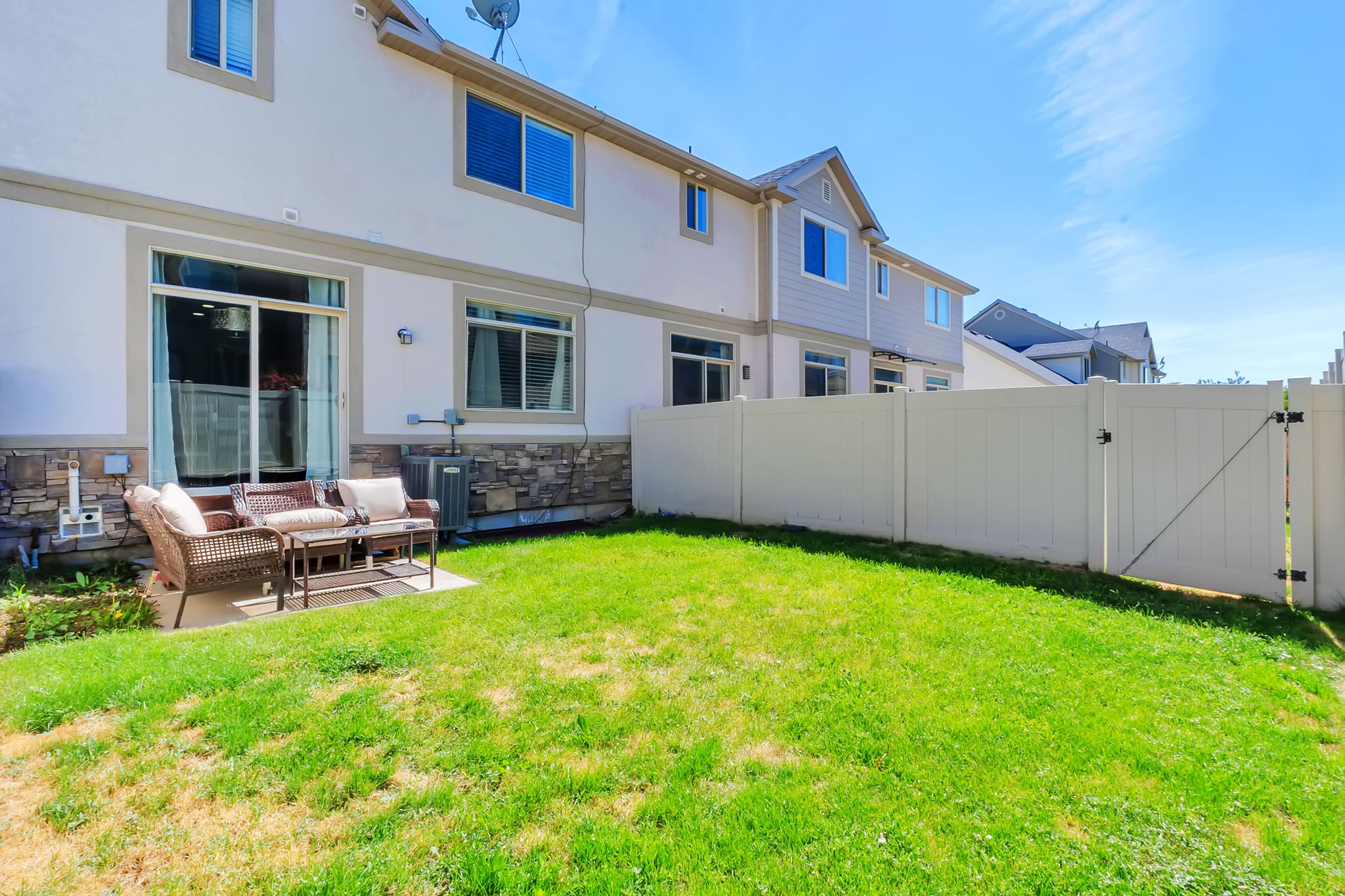Private backyard featuring a manicured lawn and a full privacy fence with gate