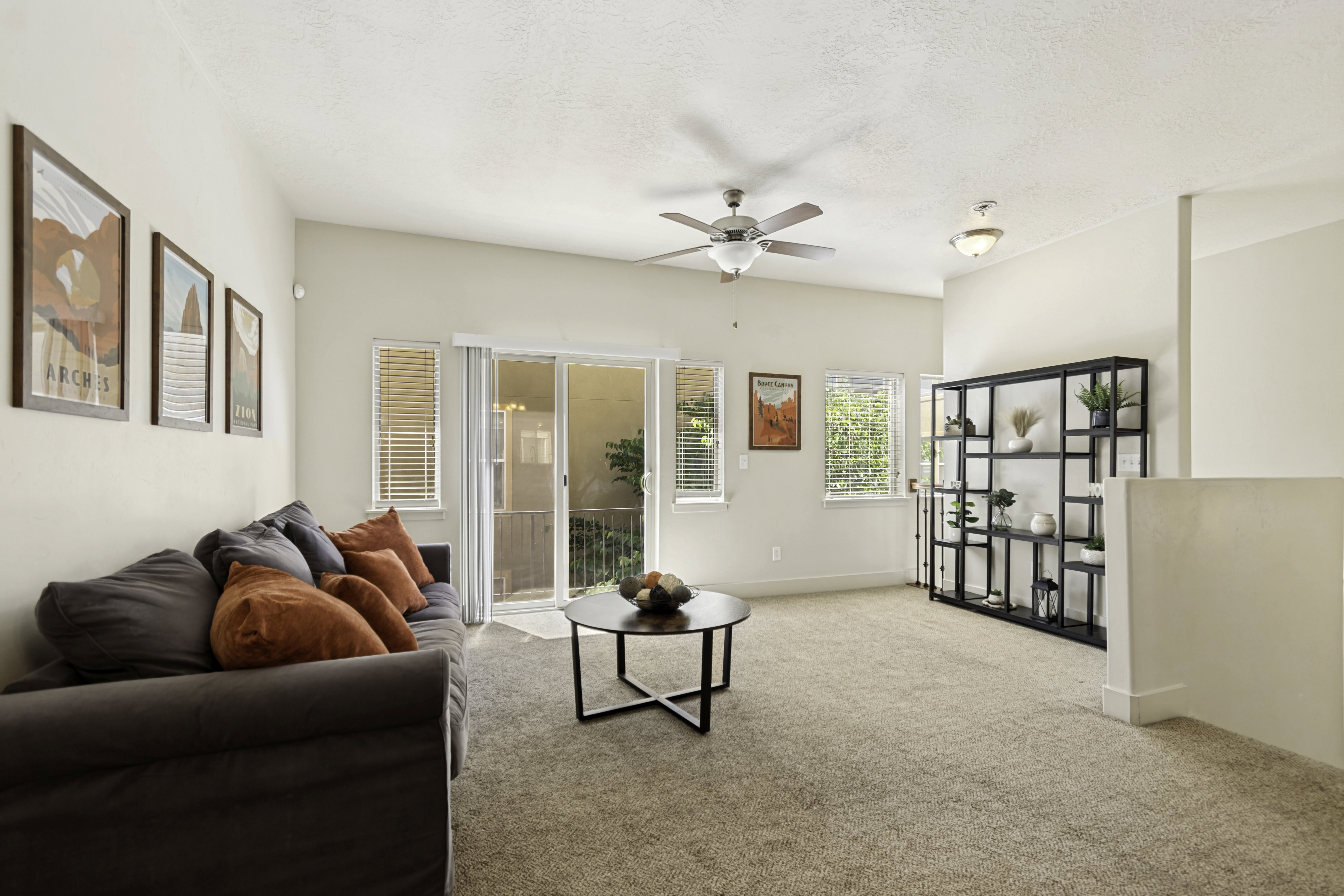 Spacious living area featuring neutral carpeting and light-toned walls