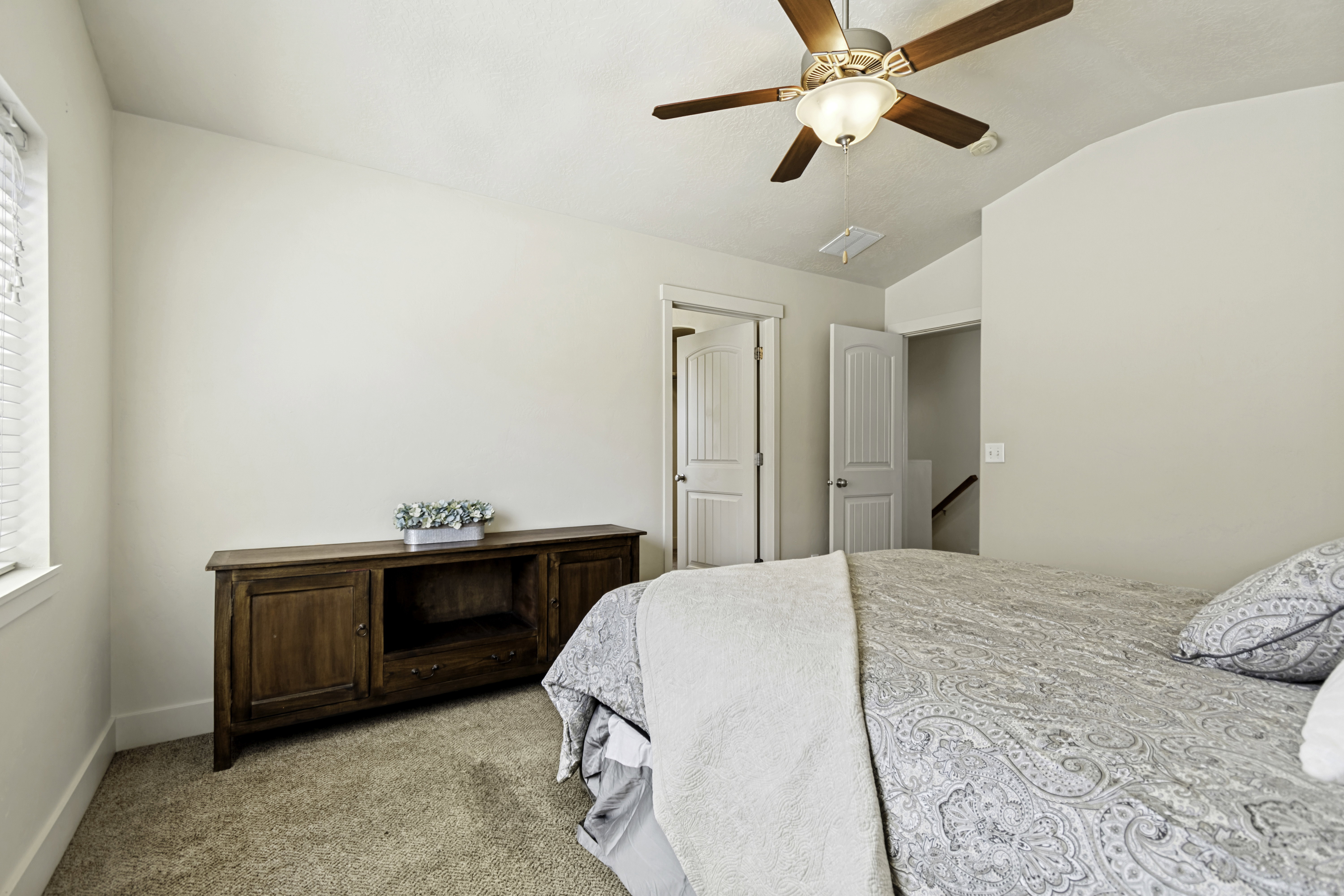 Room featuring light beige walls and brown carpet flooring