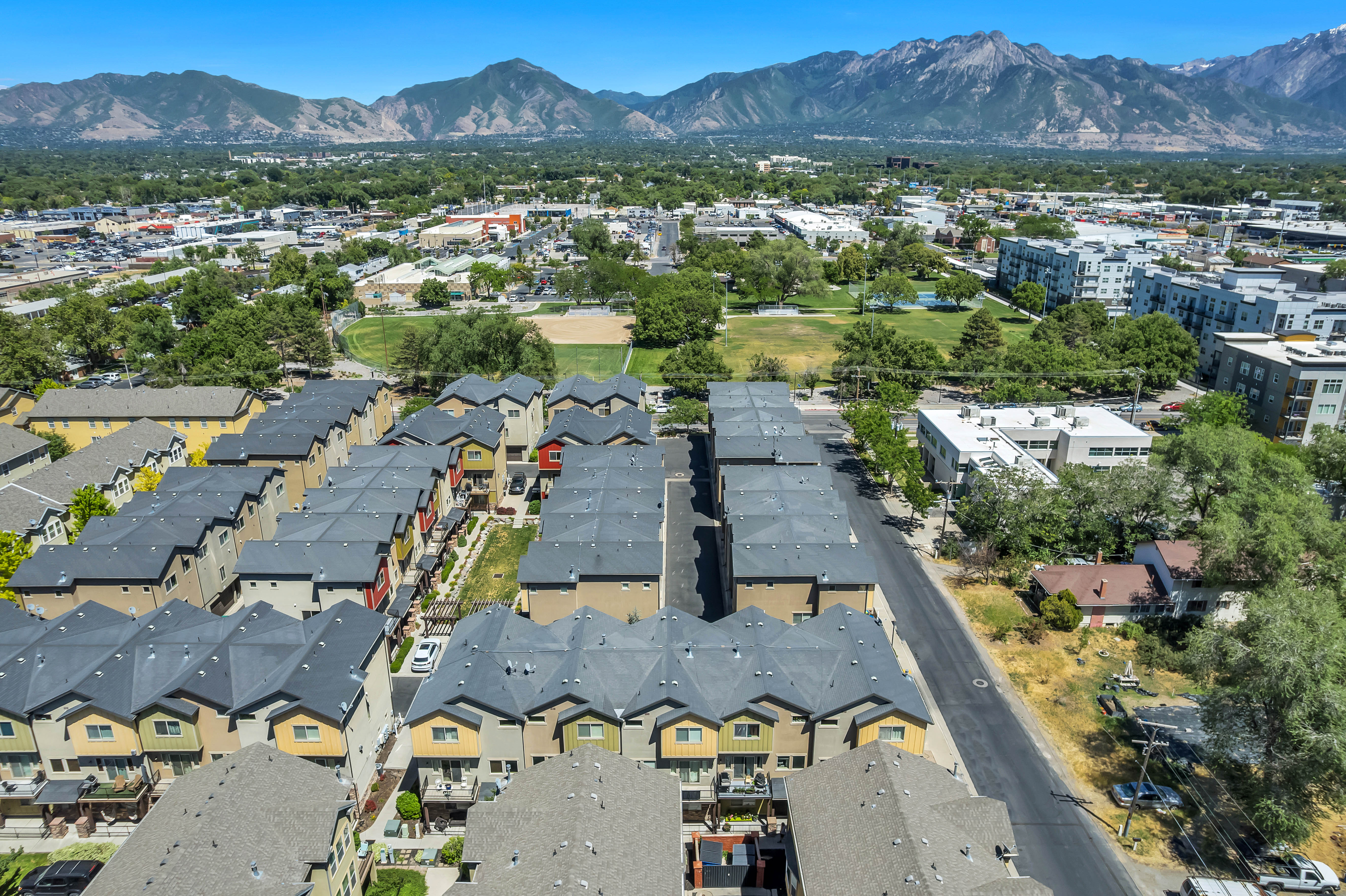 Townhome community featuring multi-story residences with private balconies and dark-toned roofing