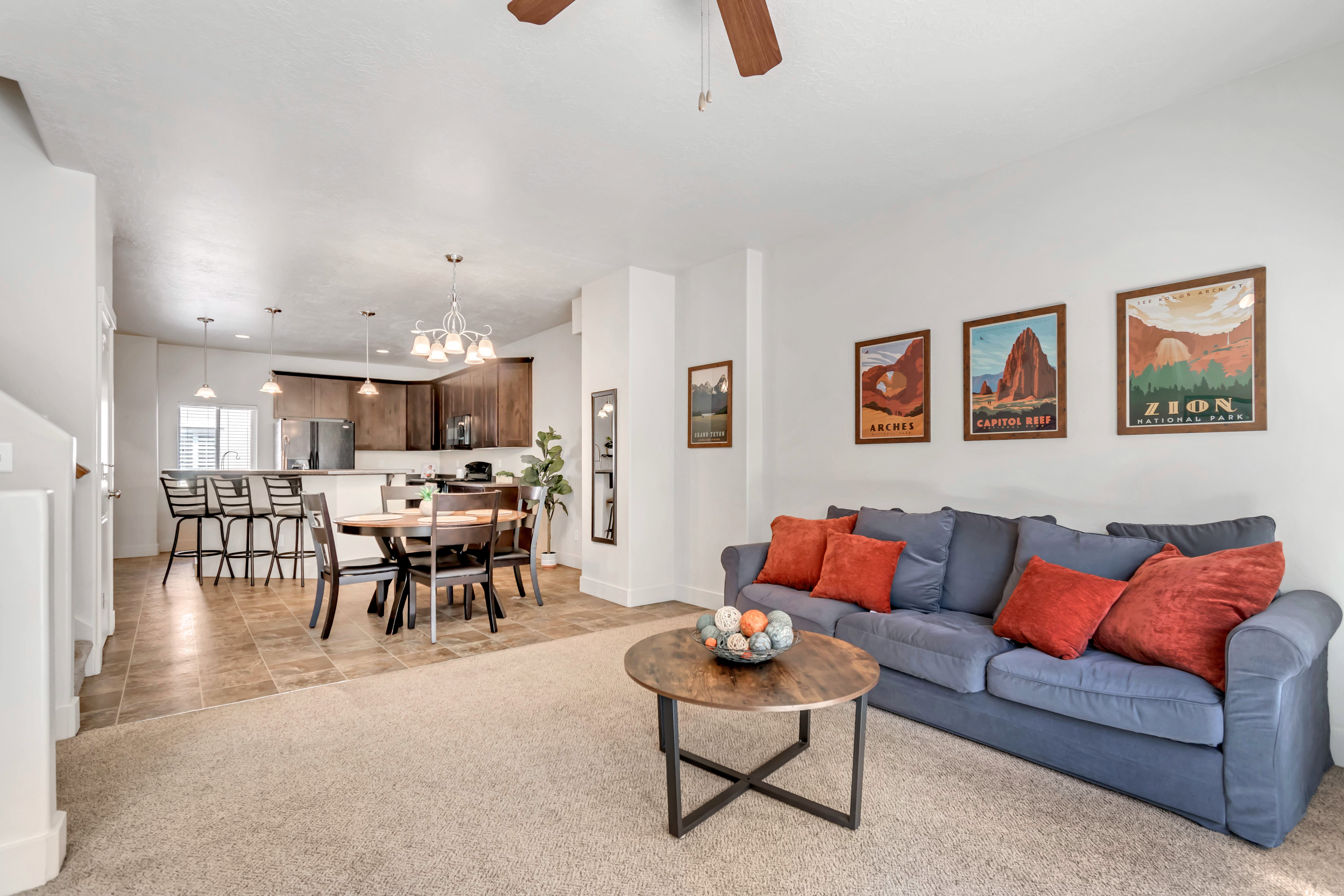 Open concept living area featuring light-toned carpeting and neutral wall finishes