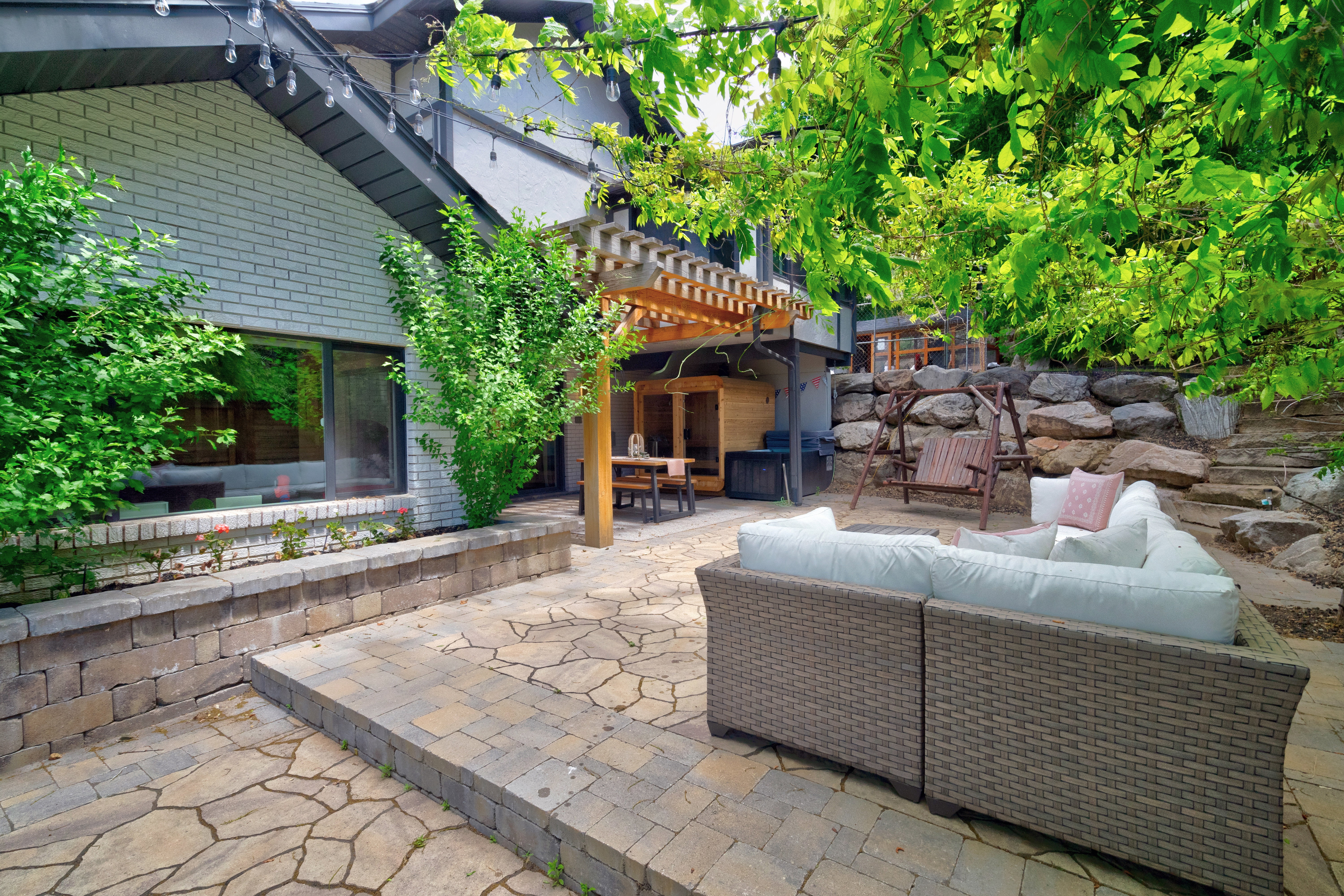 Tiered stone patio featuring flagstone and paver sections