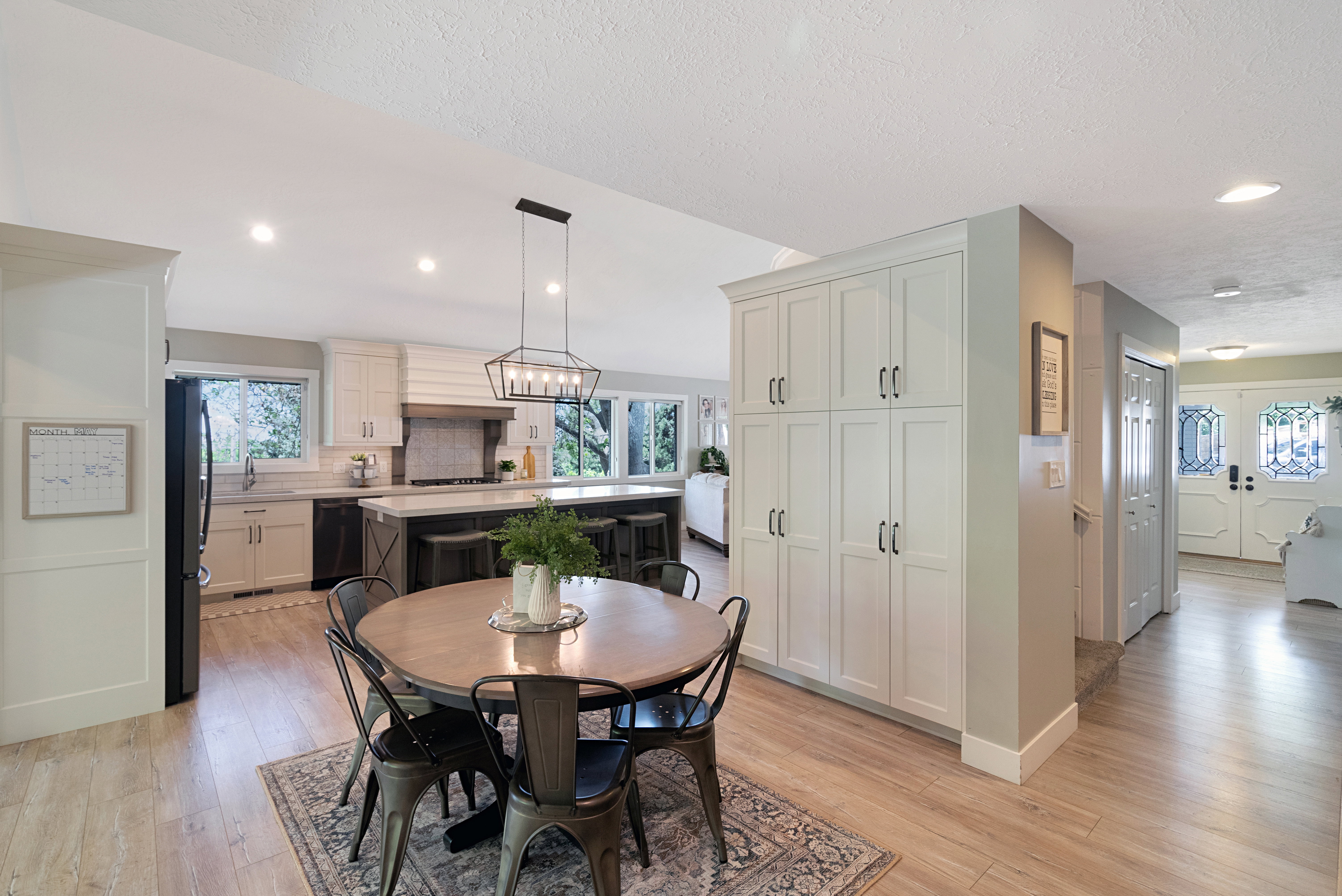 Open-concept kitchen and dining area featuring light wood-finish flooring