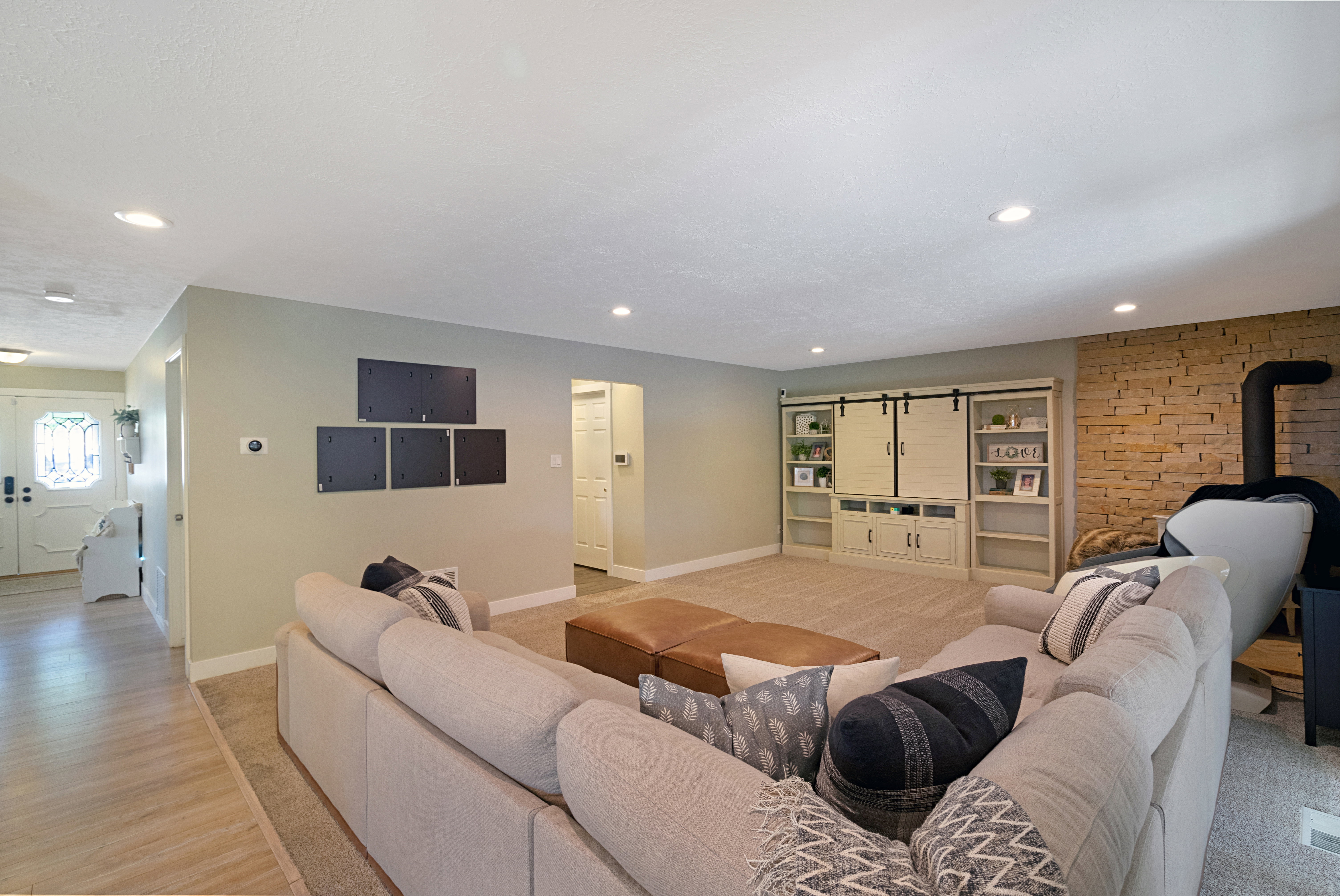 Spacious living area featuring recessed lighting, light-toned wall finishes, and carpet flooring