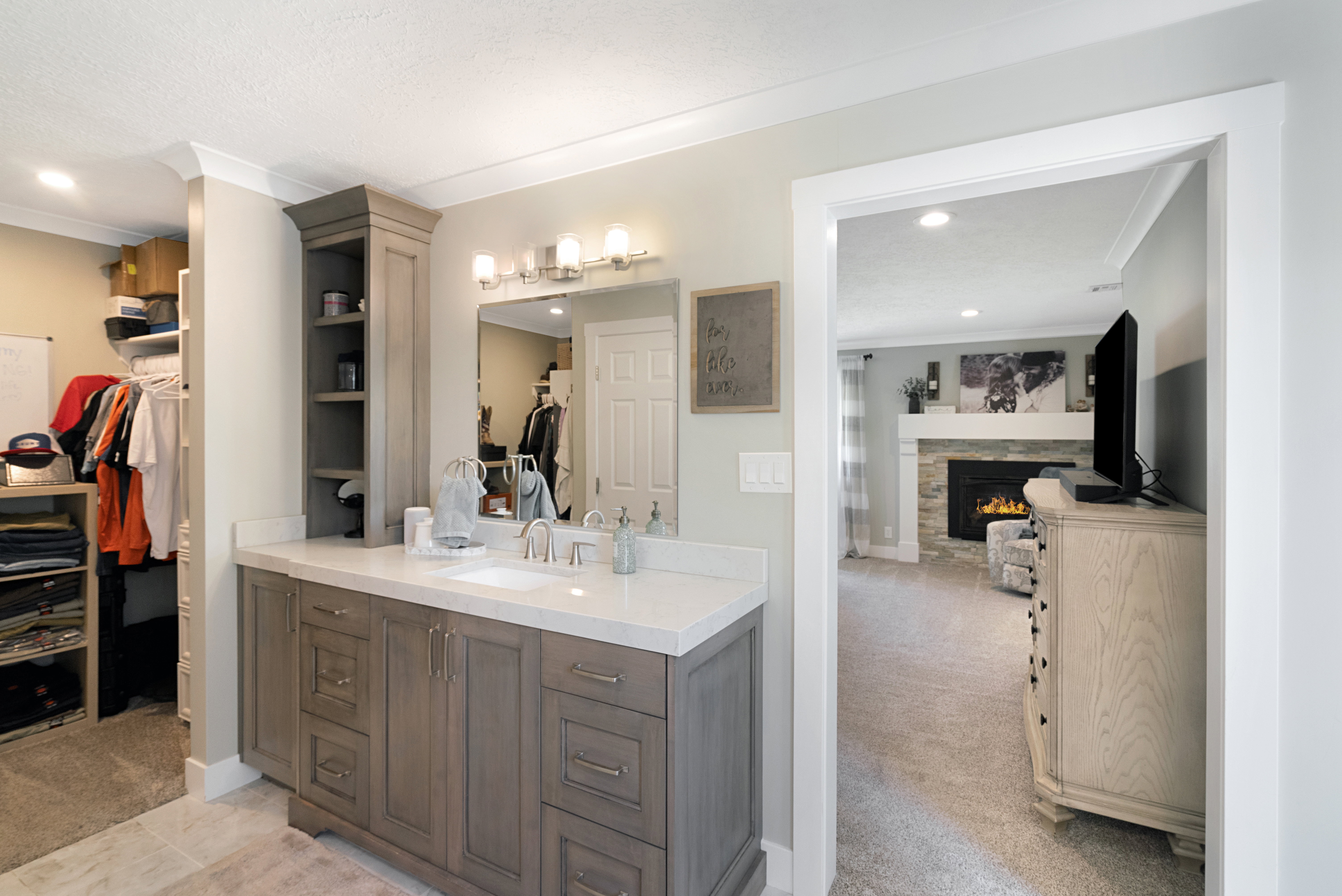 Bathroom vanity featuring a single sink, quartz countertop, and brushed nickel fixtures