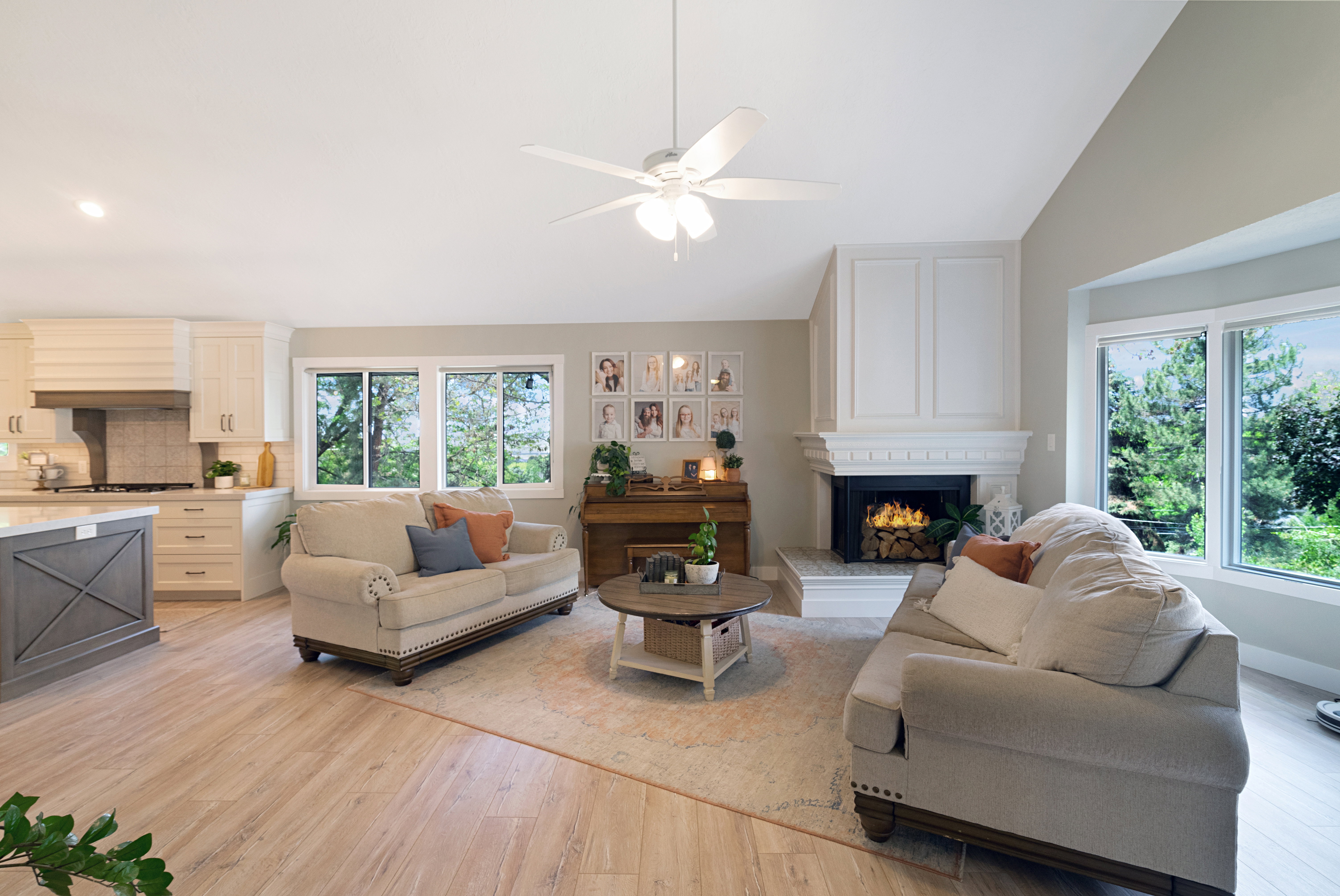 Open-concept living space featuring a vaulted ceiling and wood-finish flooring