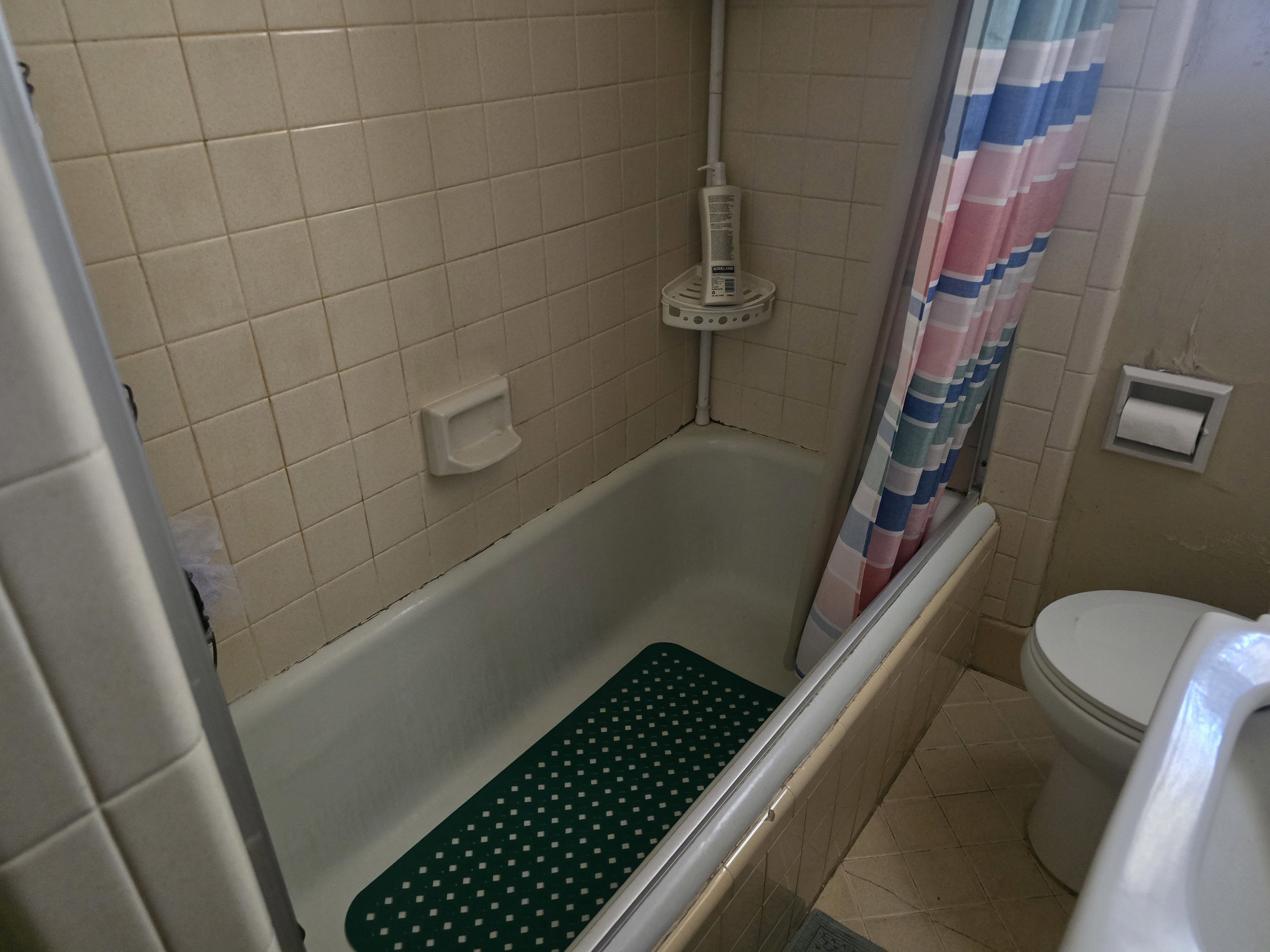 White tub-shower combination with tiled surround