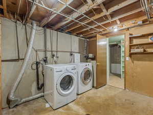 Utility area featuring concrete flooring, exposed ceiling joists, wall-mounted shelving, and a separate room entrance