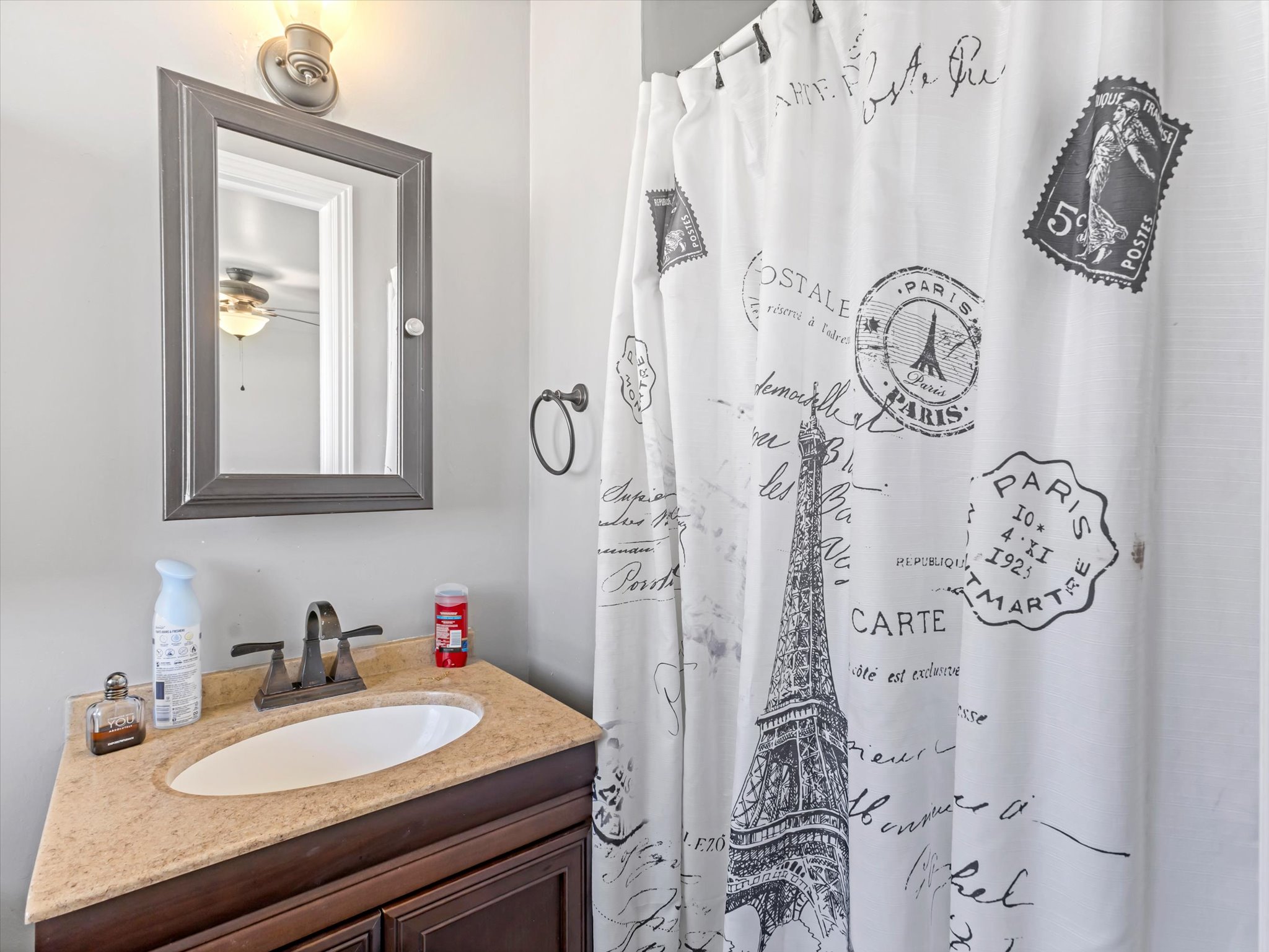 Vanity with a light-colored countertop and integrated sink basin
