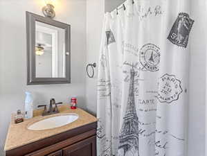 Vanity with a light-colored countertop and integrated sink basin