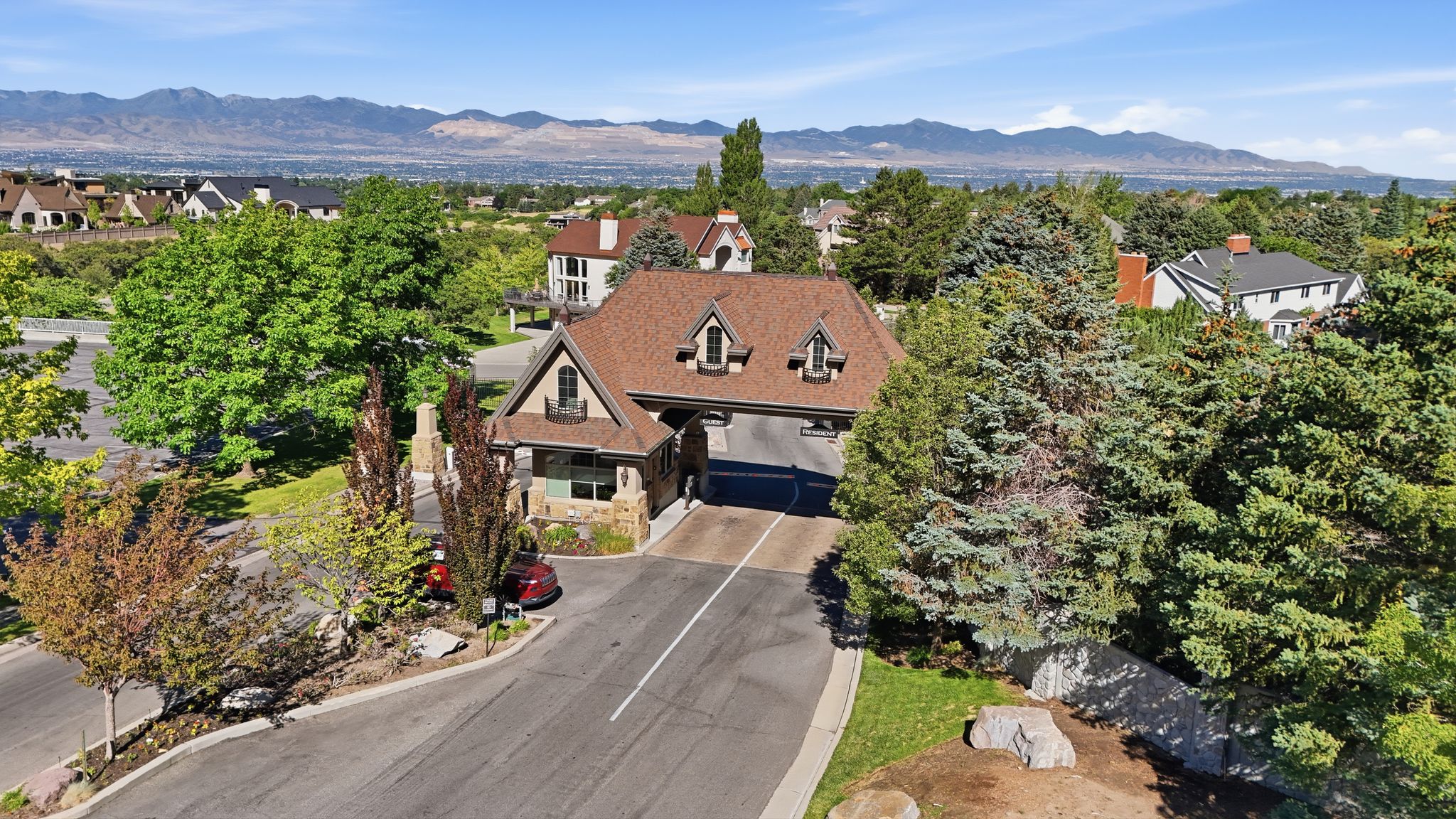 Gabled roofline residence featuring stone accents and decorative dormers