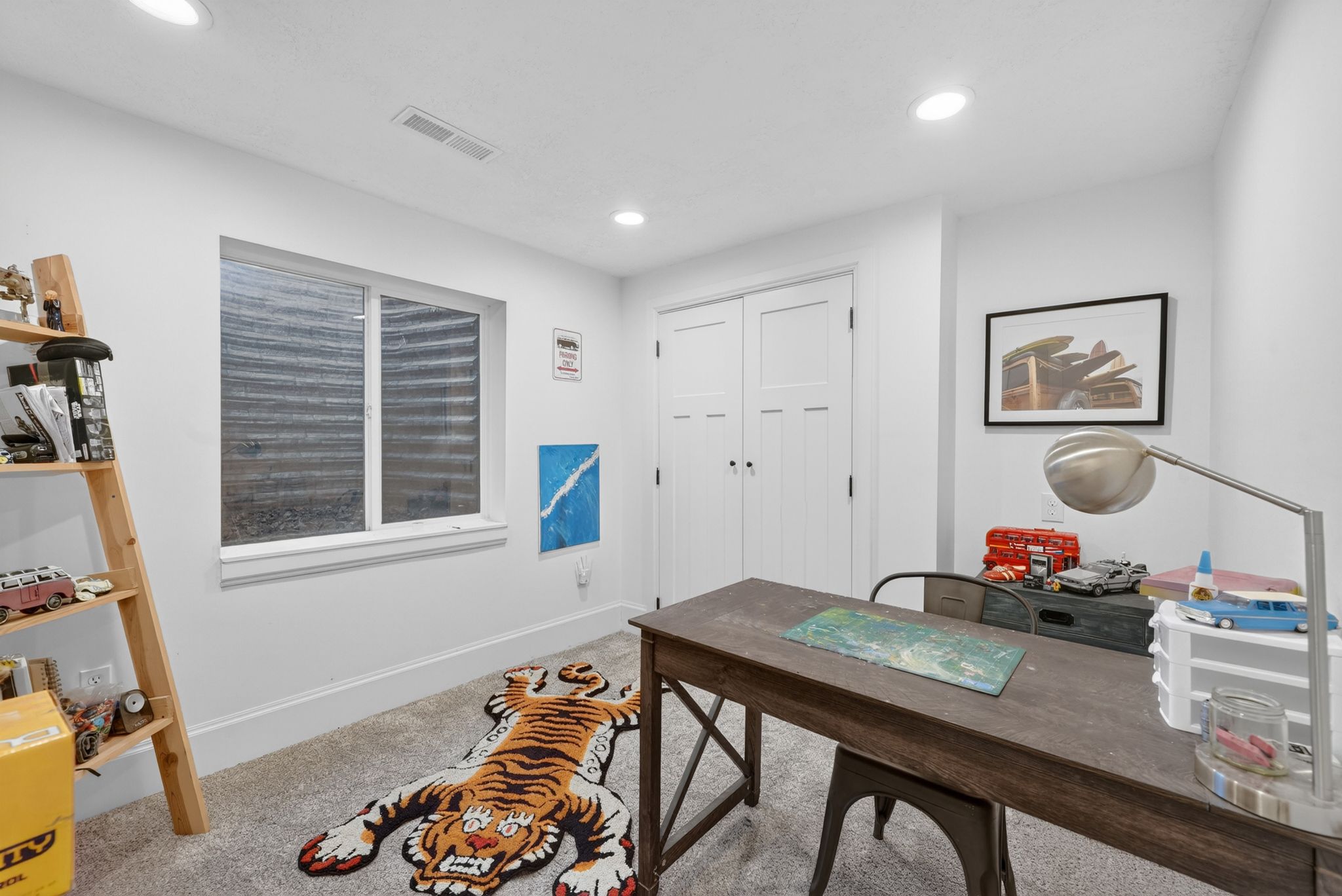 Versatile room with plush carpet flooring, recessed lighting, and a white trim window