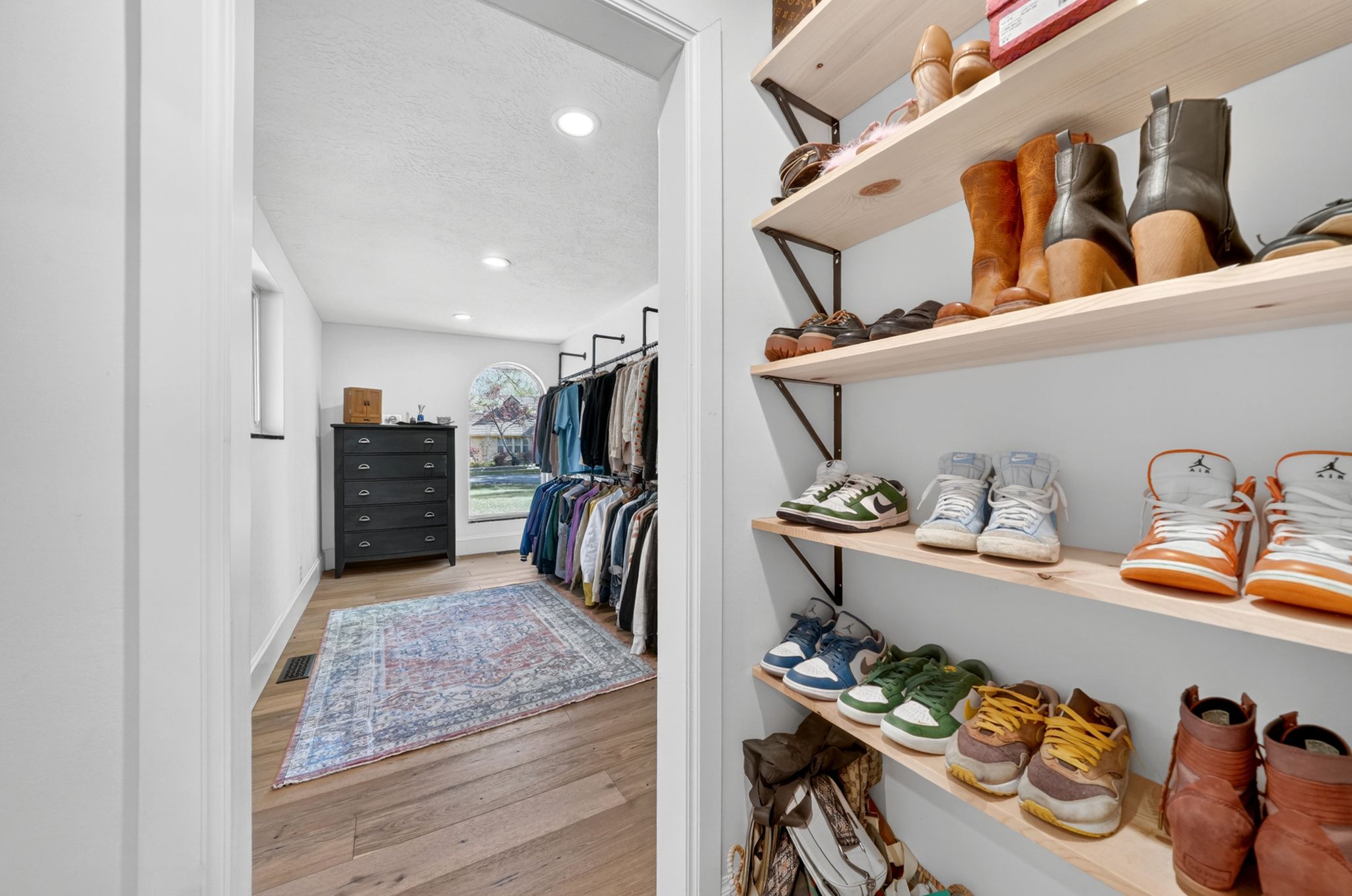 Custom closet system featuring built-in shelving and clothing racks