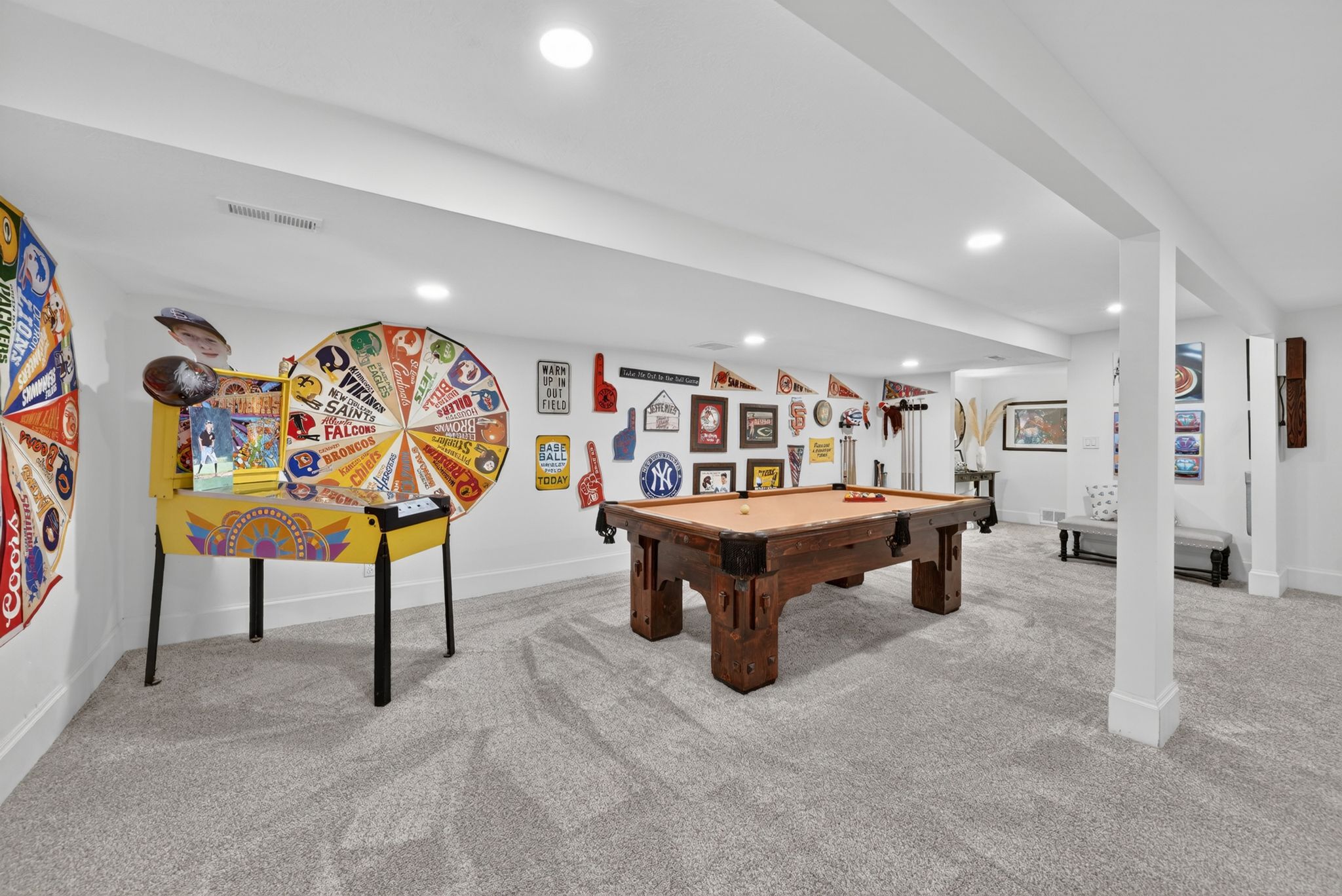 Spacious recreation area featuring a built-in pillar, recessed lighting, light gray carpeting, and white baseboards
