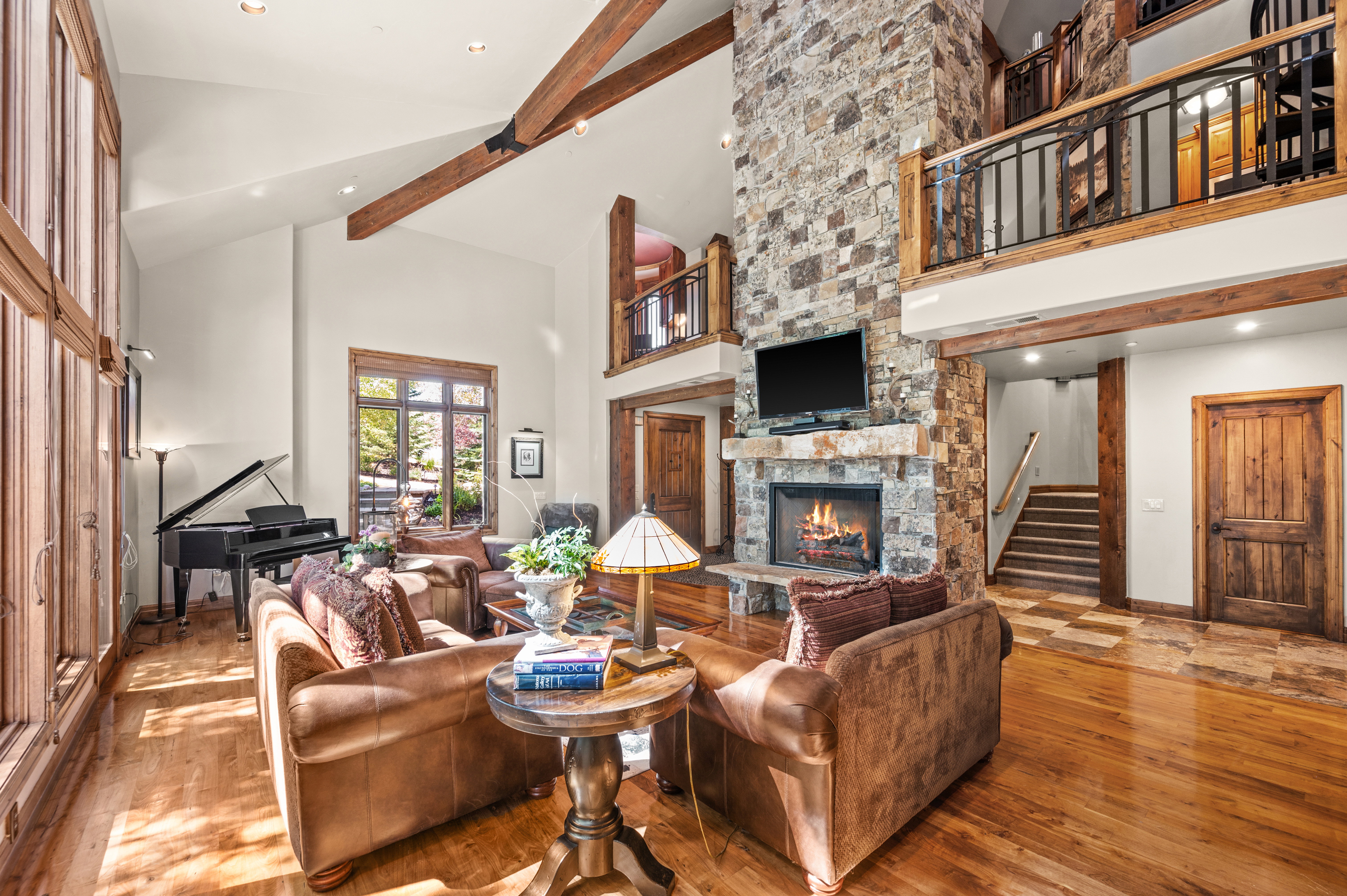 Living room featuring a fireplace, hardwood / wood-style flooring, vaulted ceiling, and recessed lighting