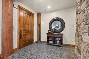 Foyer entrance with baseboards and recessed lighting
