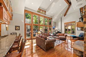Living room with recessed lighting, hardwood / wood-style floors, and vaulted ceiling