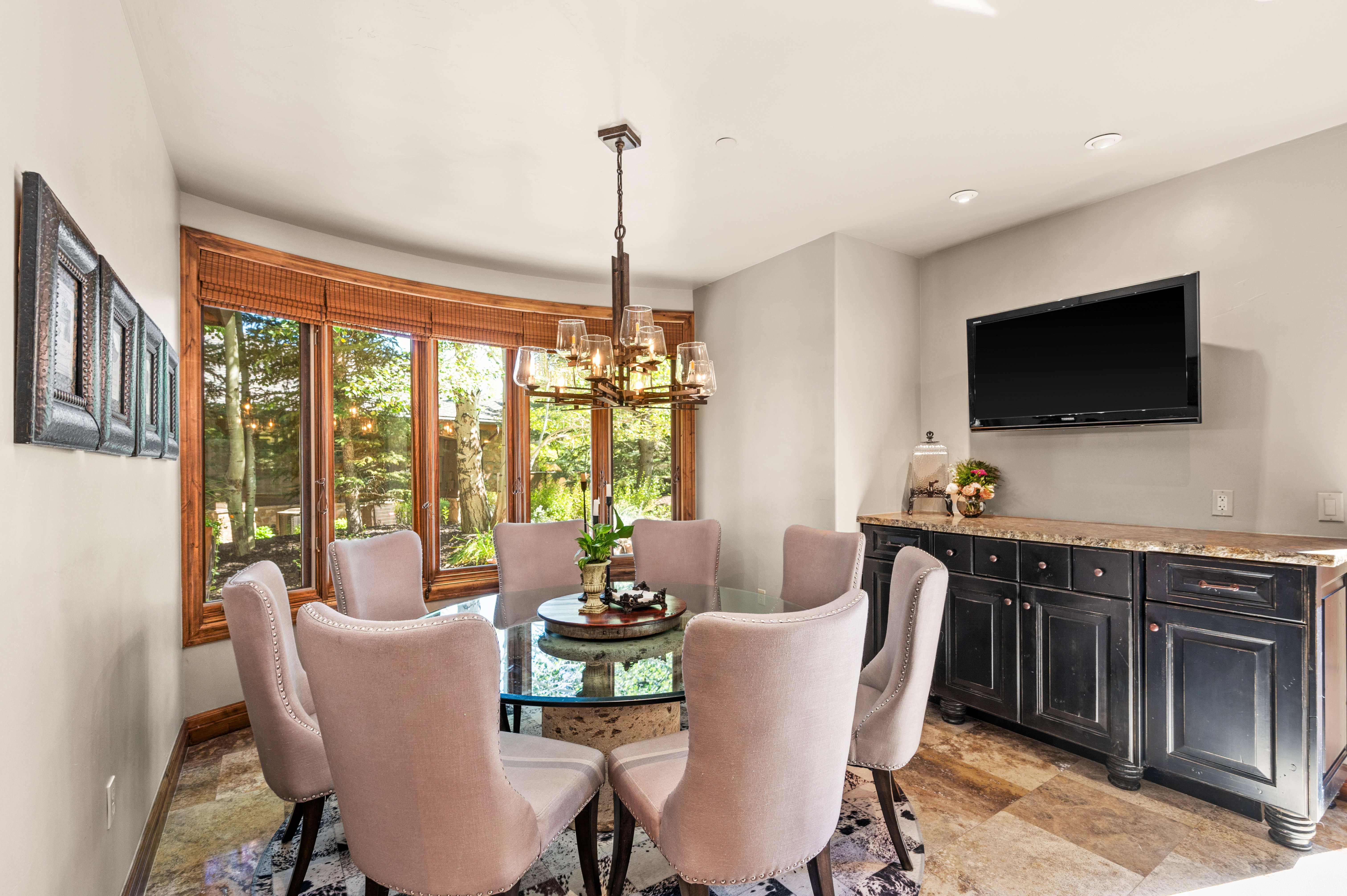 Dining room featuring light stone finish flooring and hanging lights