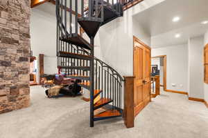 Stairway with carpet flooring, recessed lighting, and a high ceiling