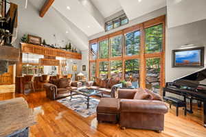 Living area with recessed lighting, light wood-style flooring, and vaulted ceiling
