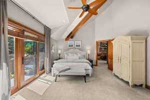 Bedroom with light colored carpet, a ceiling fan, and lofted ceiling
