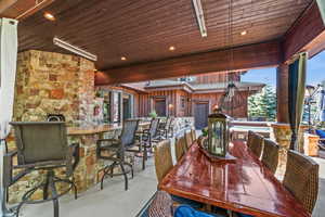 View of patio featuring an outdoor bar and dining area