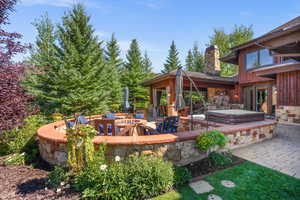 View of patio with a covered hot tub