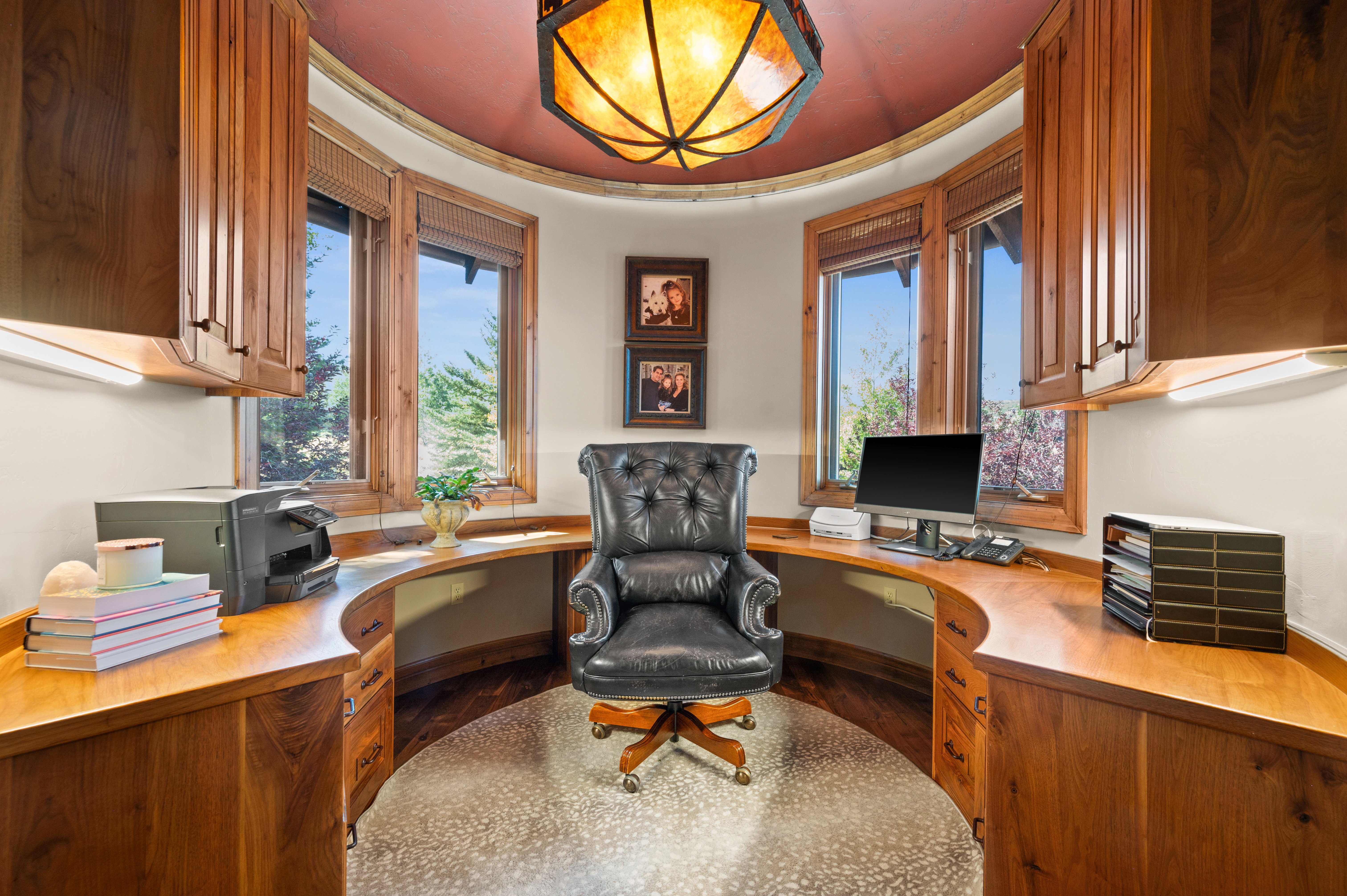 Office space with built in study area, dark wood finished floors, and healthy amount of natural light