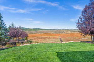 View of green lawn featuring a mountain view