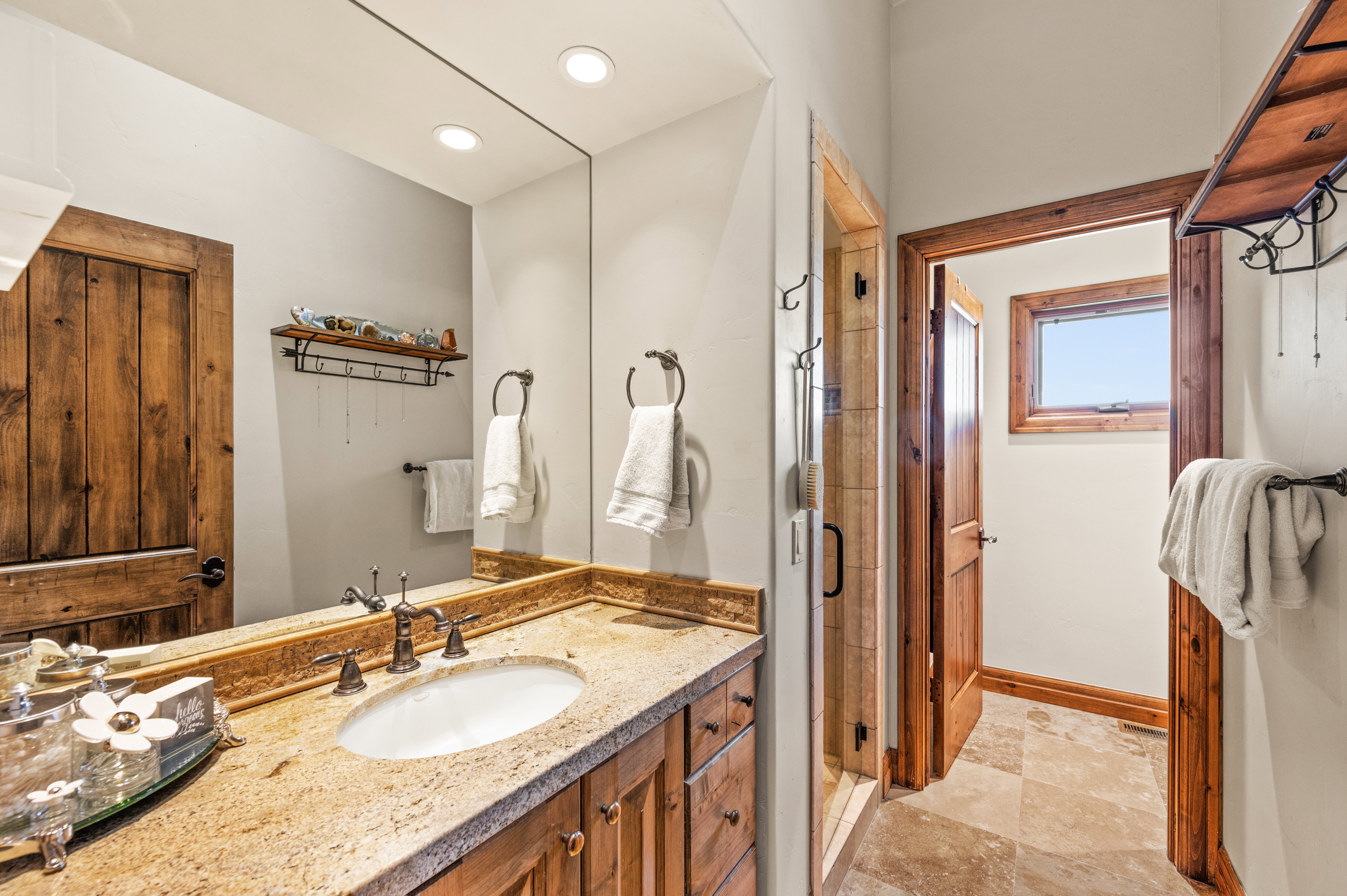 Full bathroom with vanity, a shower stall, light stone finish floors, and recessed lighting