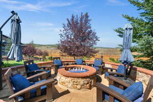 View of patio with an outdoor fire pit