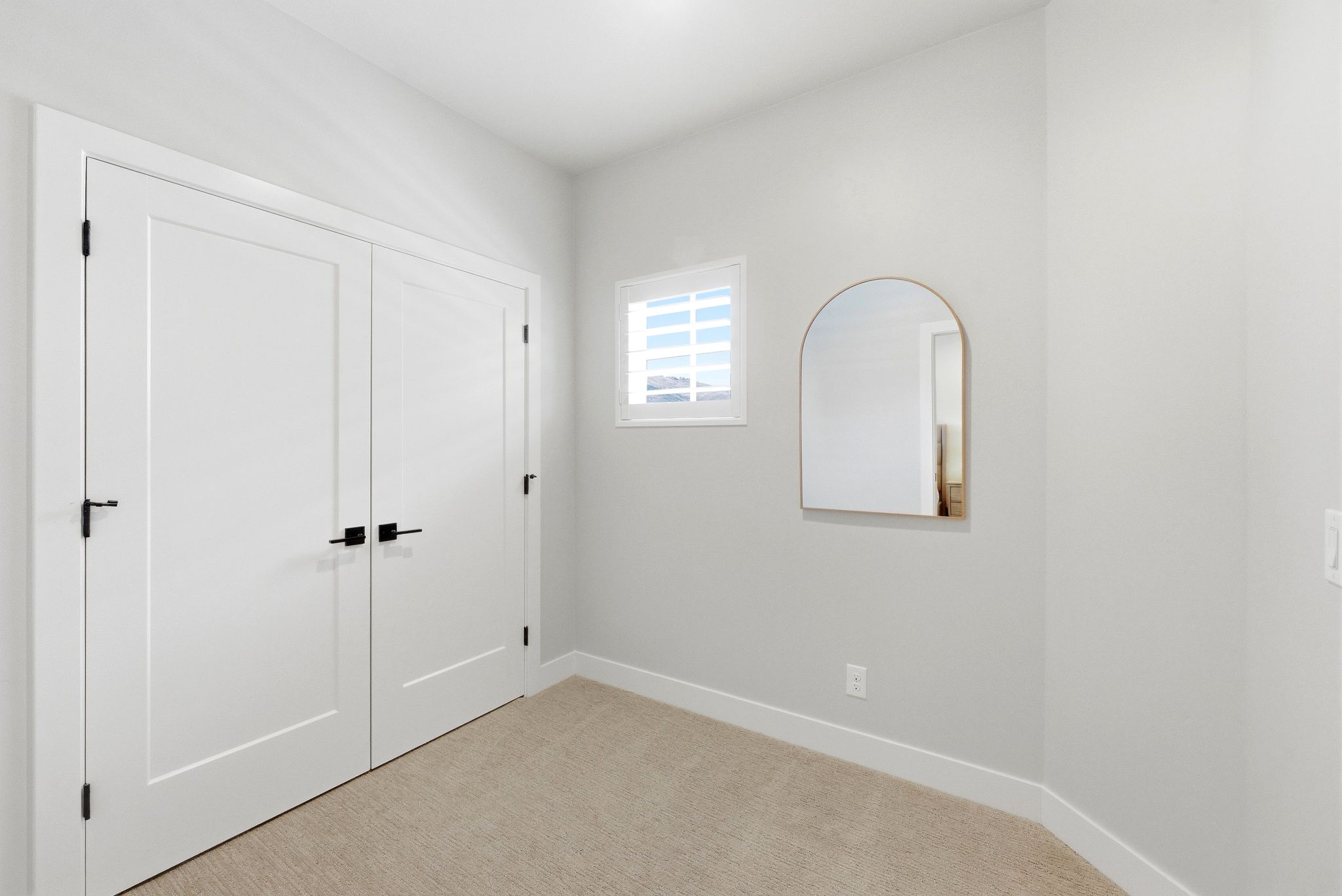Room featuring neutral wall tones and light-colored carpet flooring