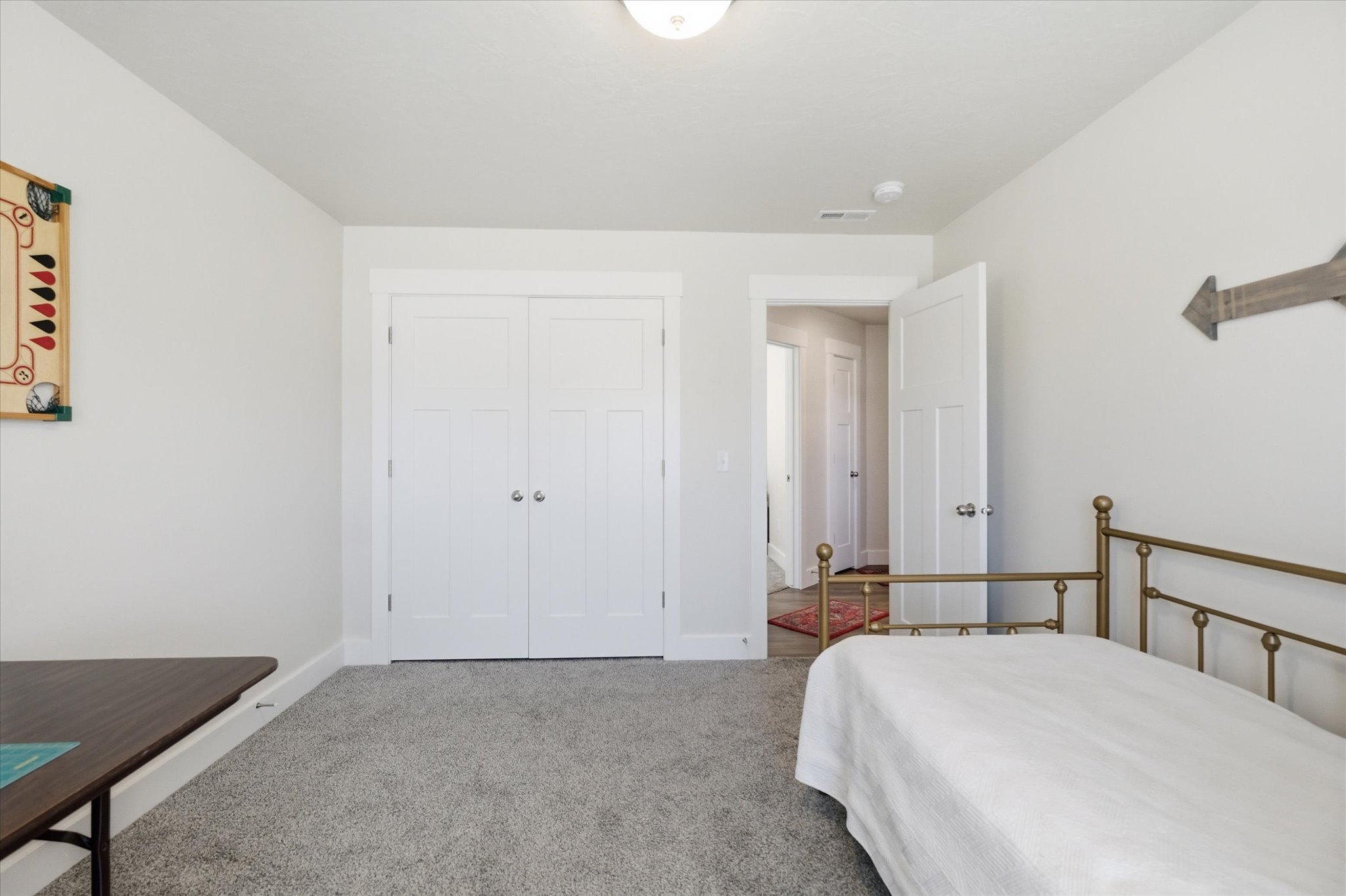 Room with light gray walls and gray carpet flooring