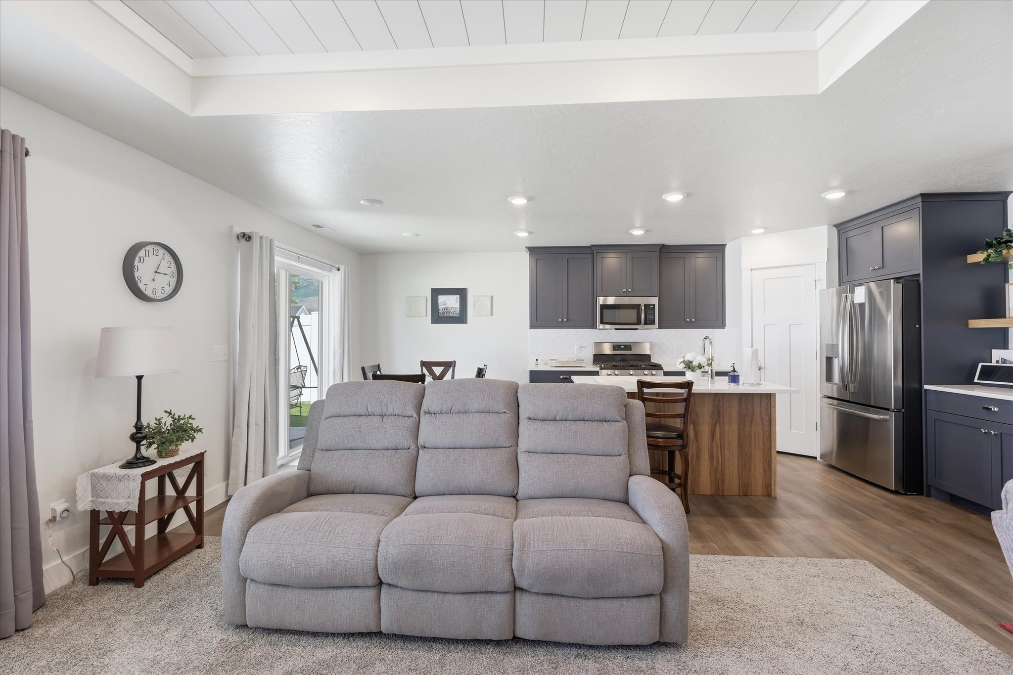 Living area with wood-finish flooring and recessed lighting