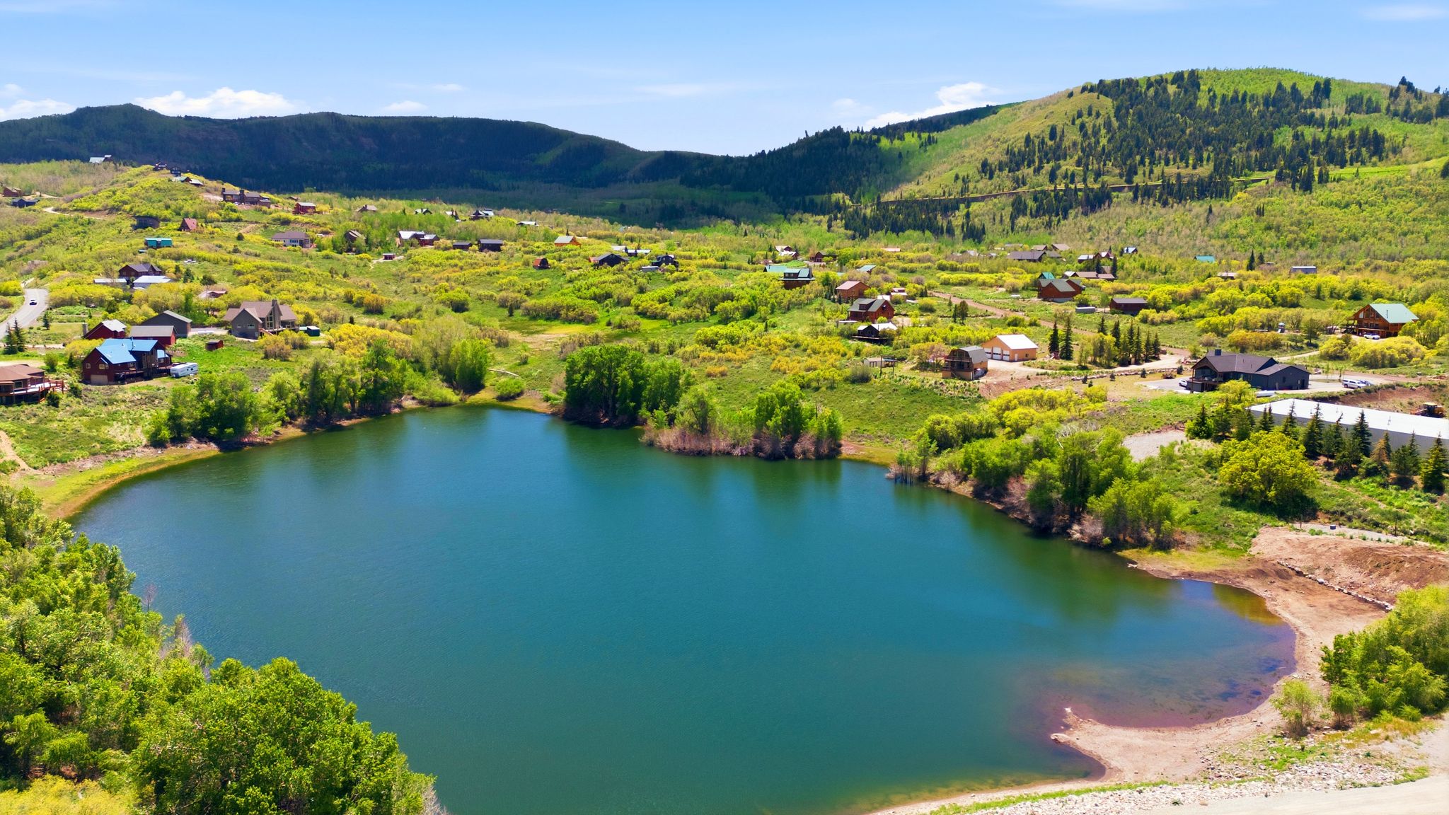 Expansive lake with surrounding natural landscaping