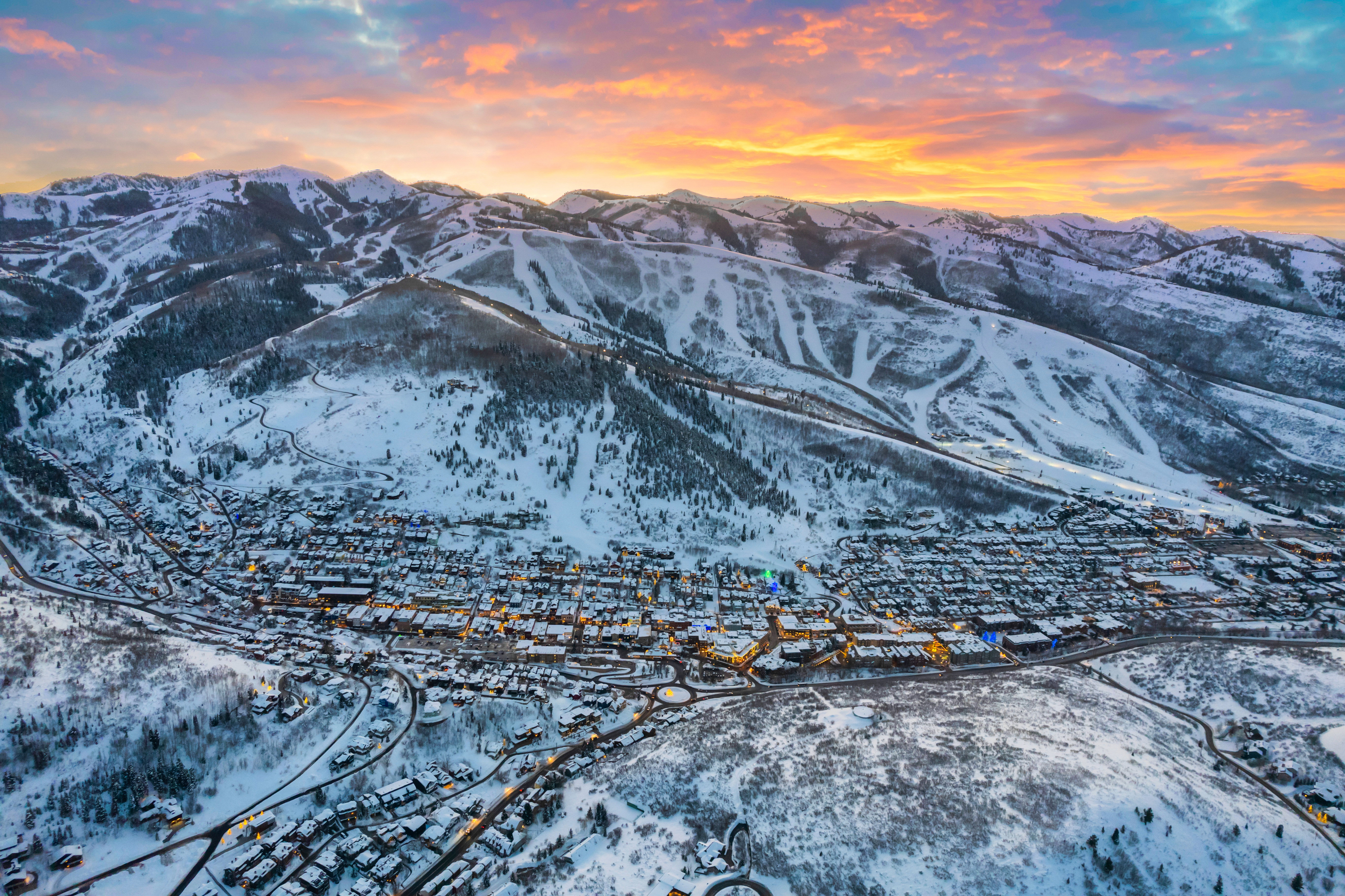 Aerial perspective showcasing a snow-covered mountain community nestled among peaks