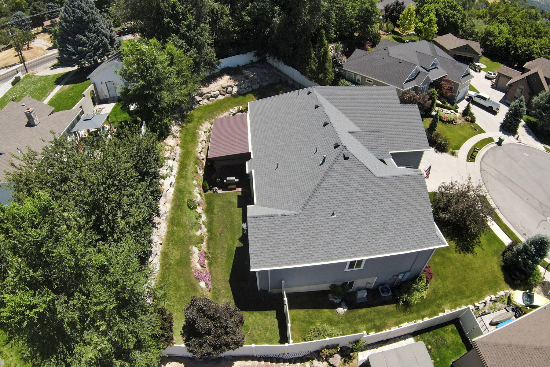 Contemporary single-family residence with a gray shingle roof and light blue siding