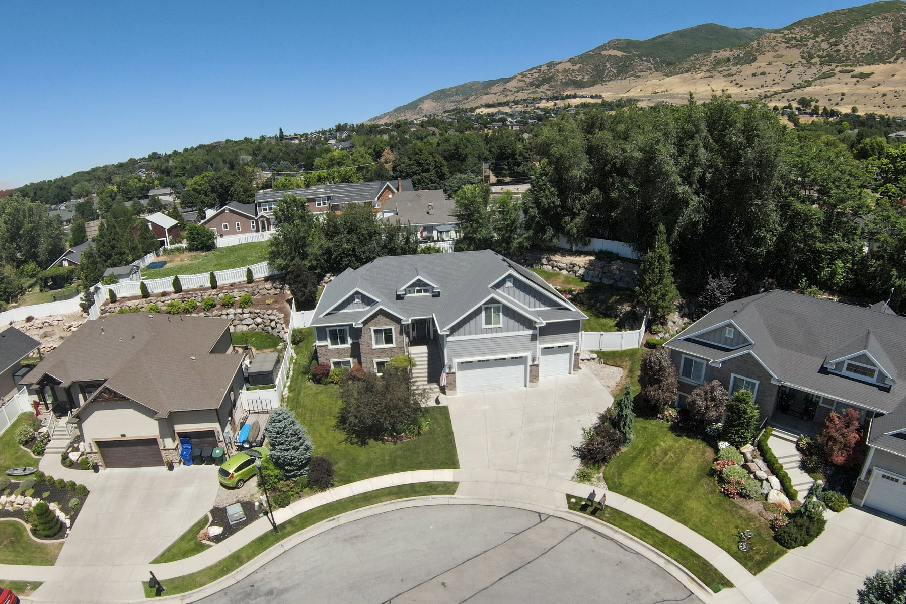 Contemporary home with a two-car garage, concrete driveway, and a landscaped front yard