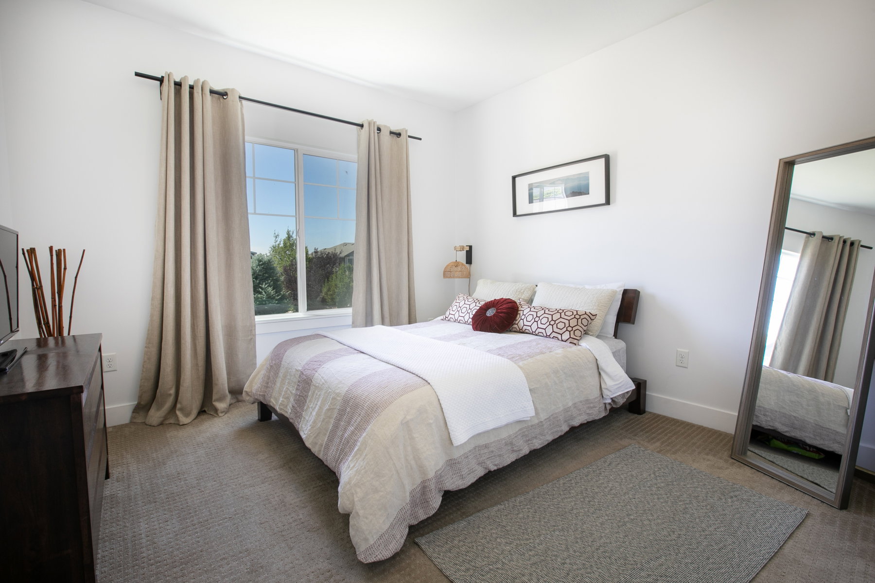 Carpeted room featuring a large window with exterior views, white walls, and crown molding
