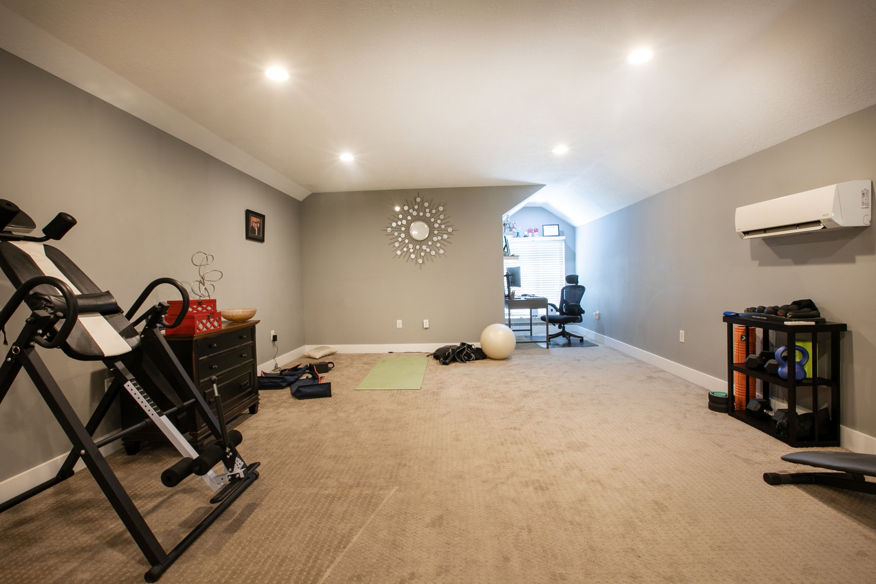 Spacious multi-purpose room featuring carpet flooring, recessed lighting, and a ductless mini-split system