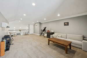Living room featuring light colored carpet and recessed lighting