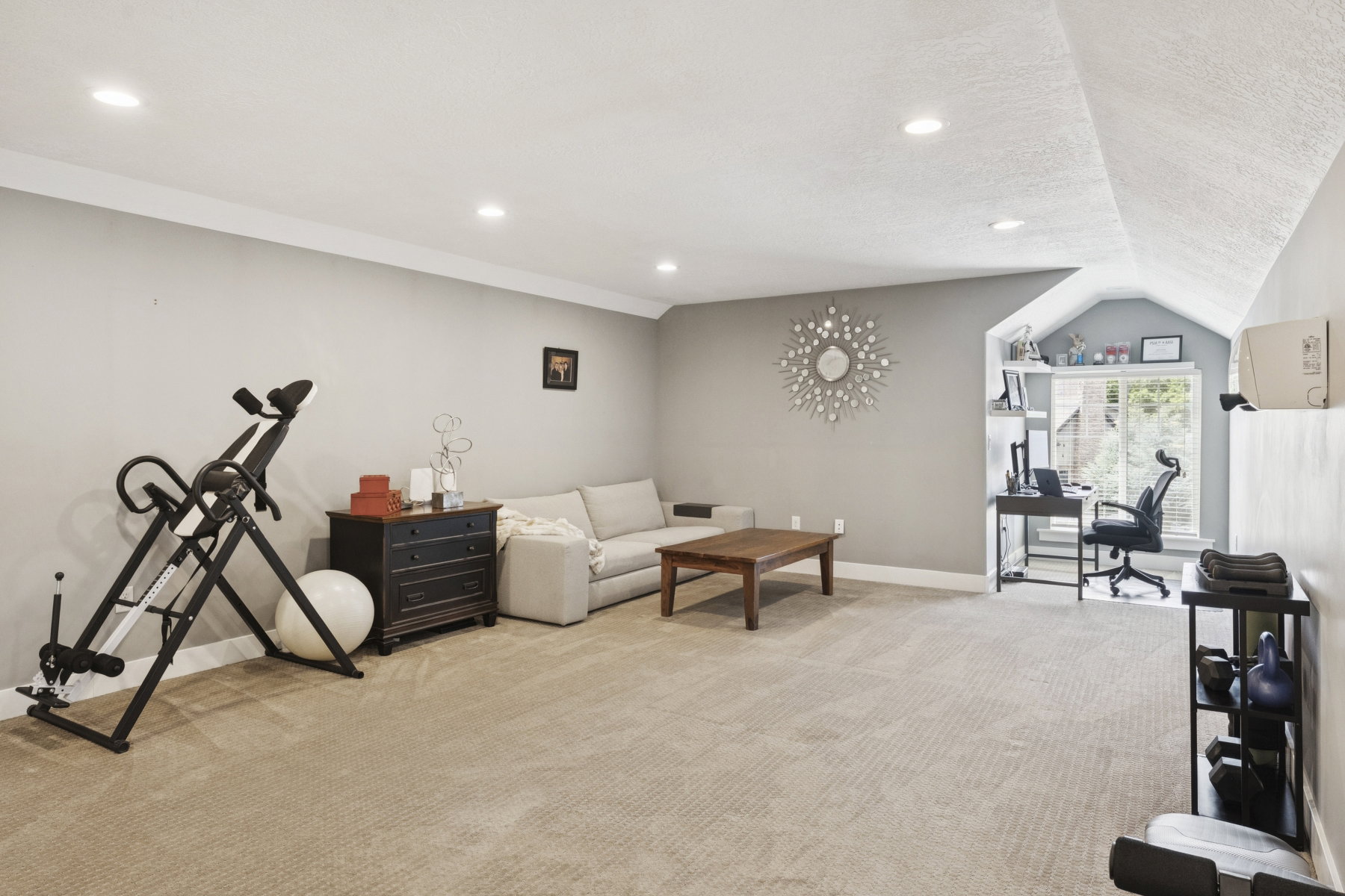Living room with light colored carpet and recessed lighting